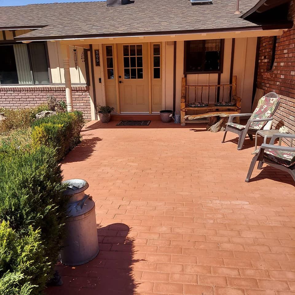 A brick walkway leading to the front door of a house
