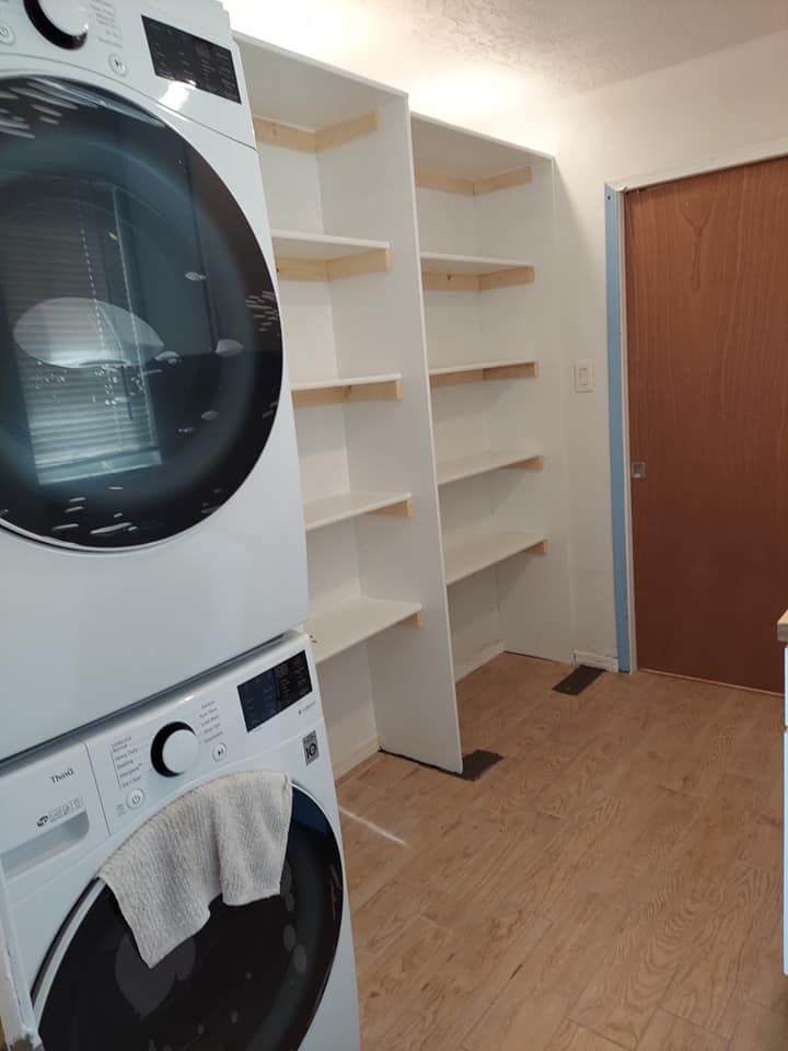 A washer and dryer are stacked on top of each other in a laundry room.