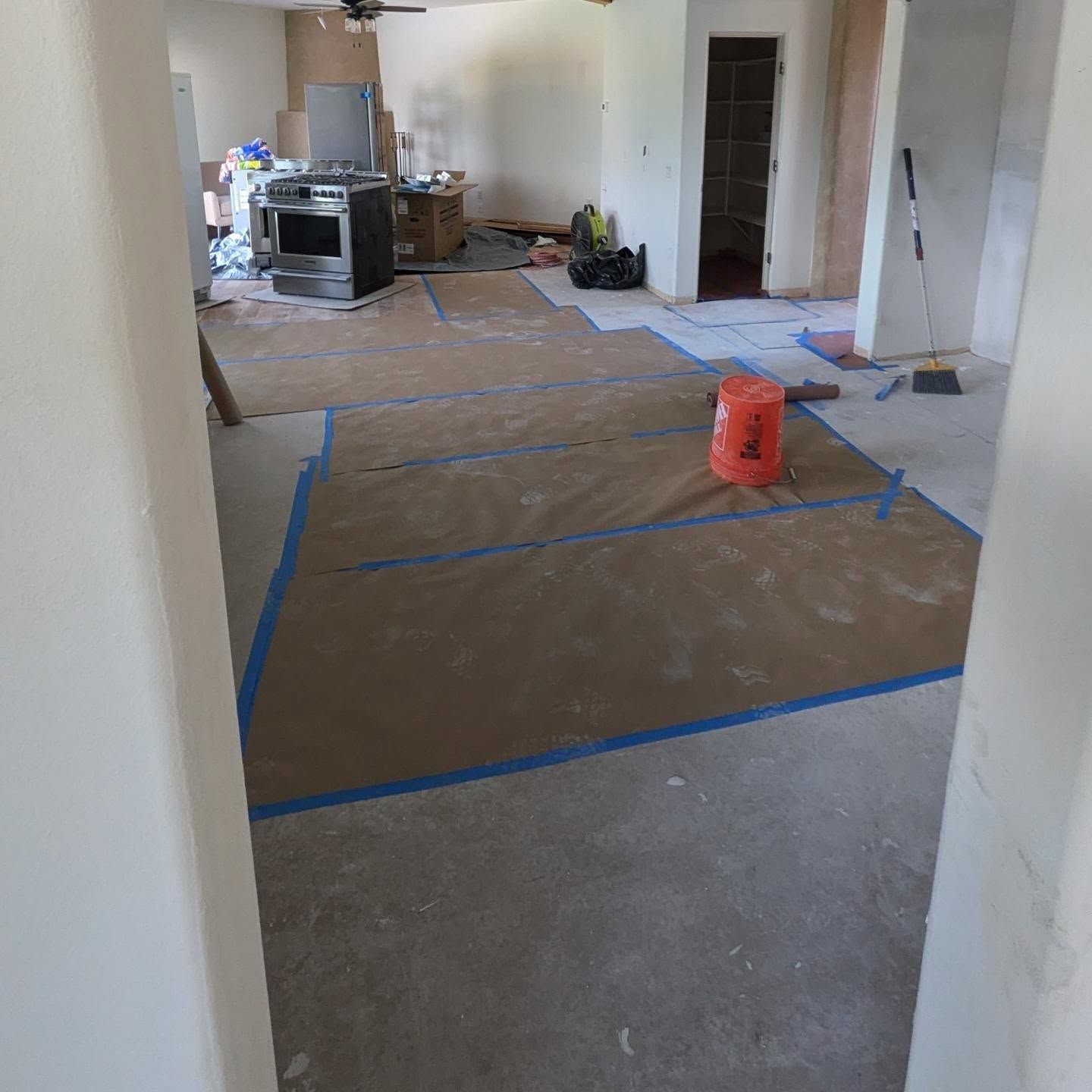 An orange bucket with the number 4 on it sits on the floor