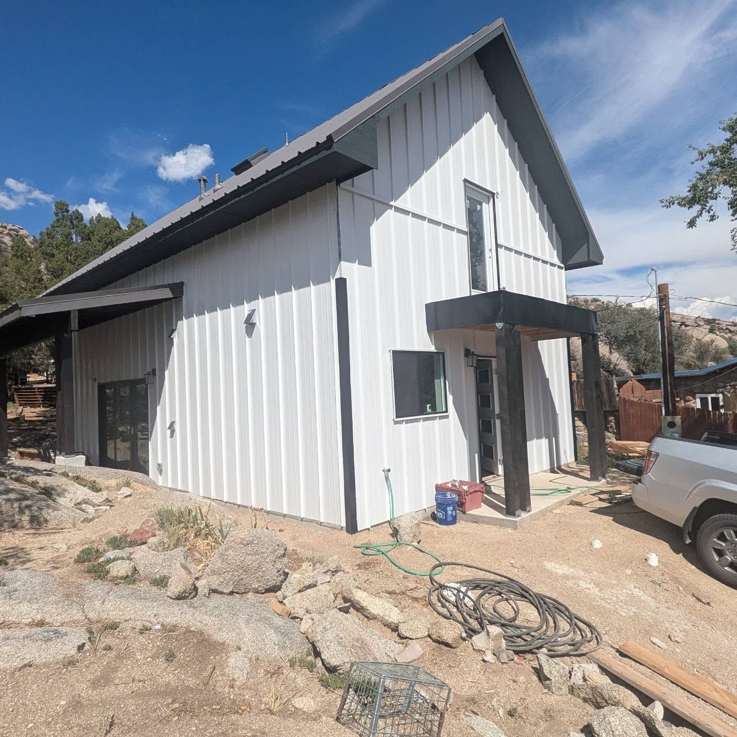 A white house with a truck parked in front of it