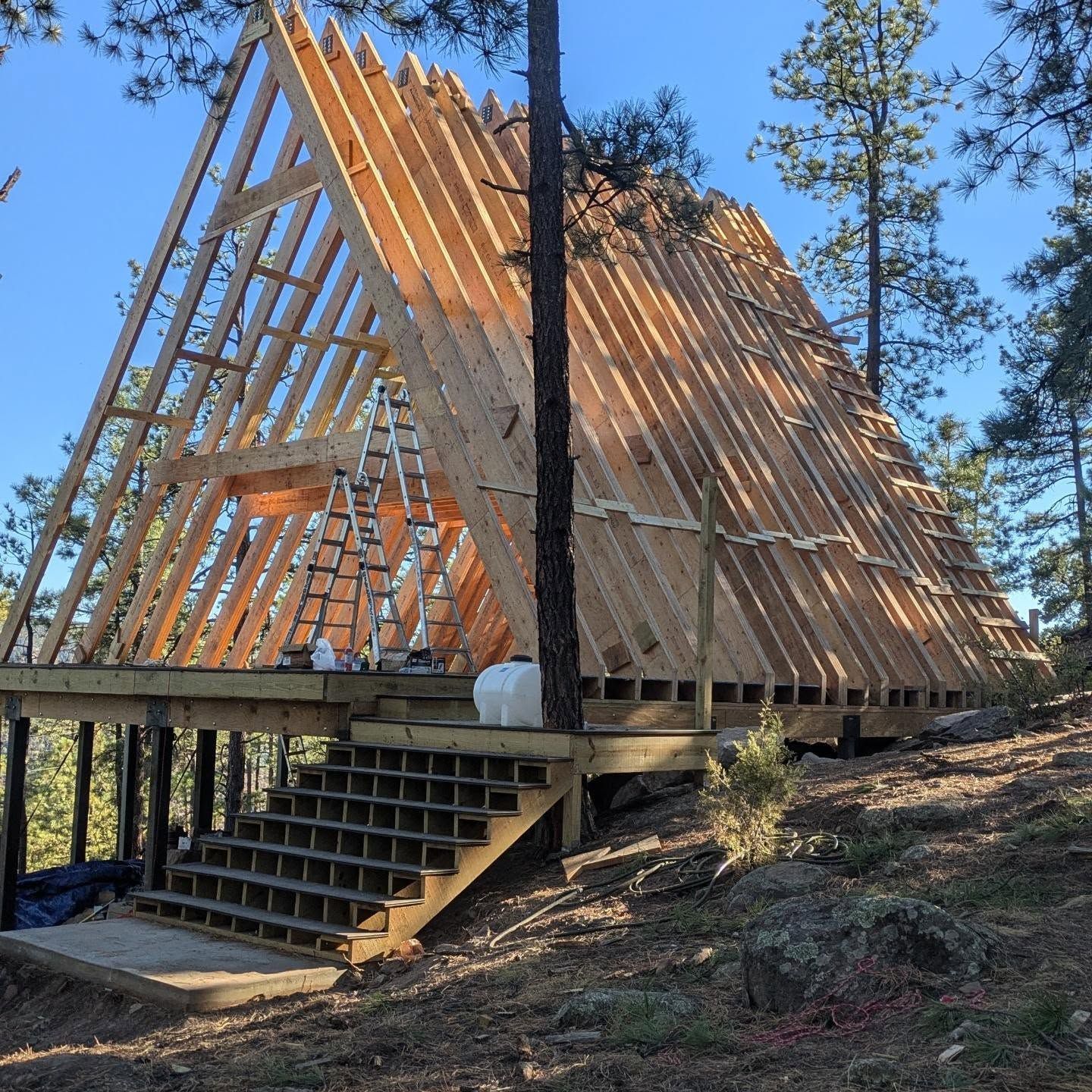 A wooden structure is being built in the woods