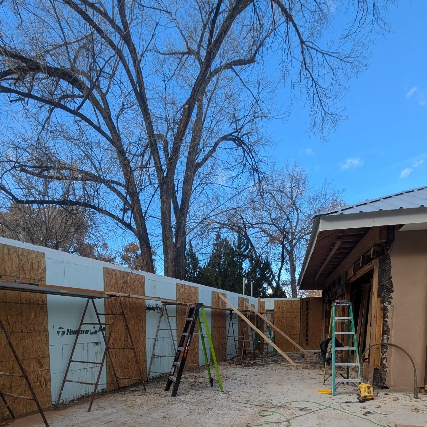 A fence is being built in front of a house