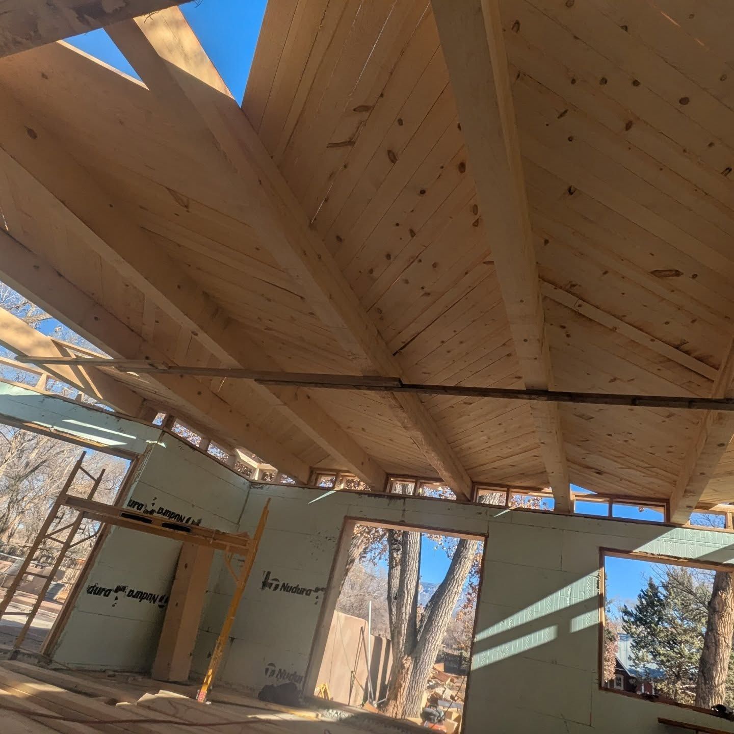 A house under construction with a roof made of wood