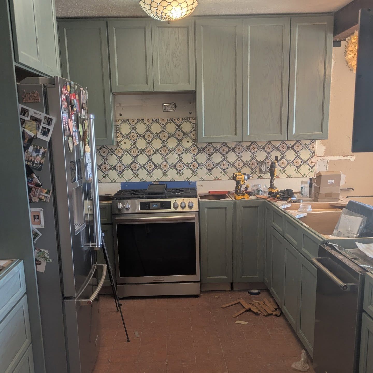 A kitchen with a stove and a refrigerator that says open