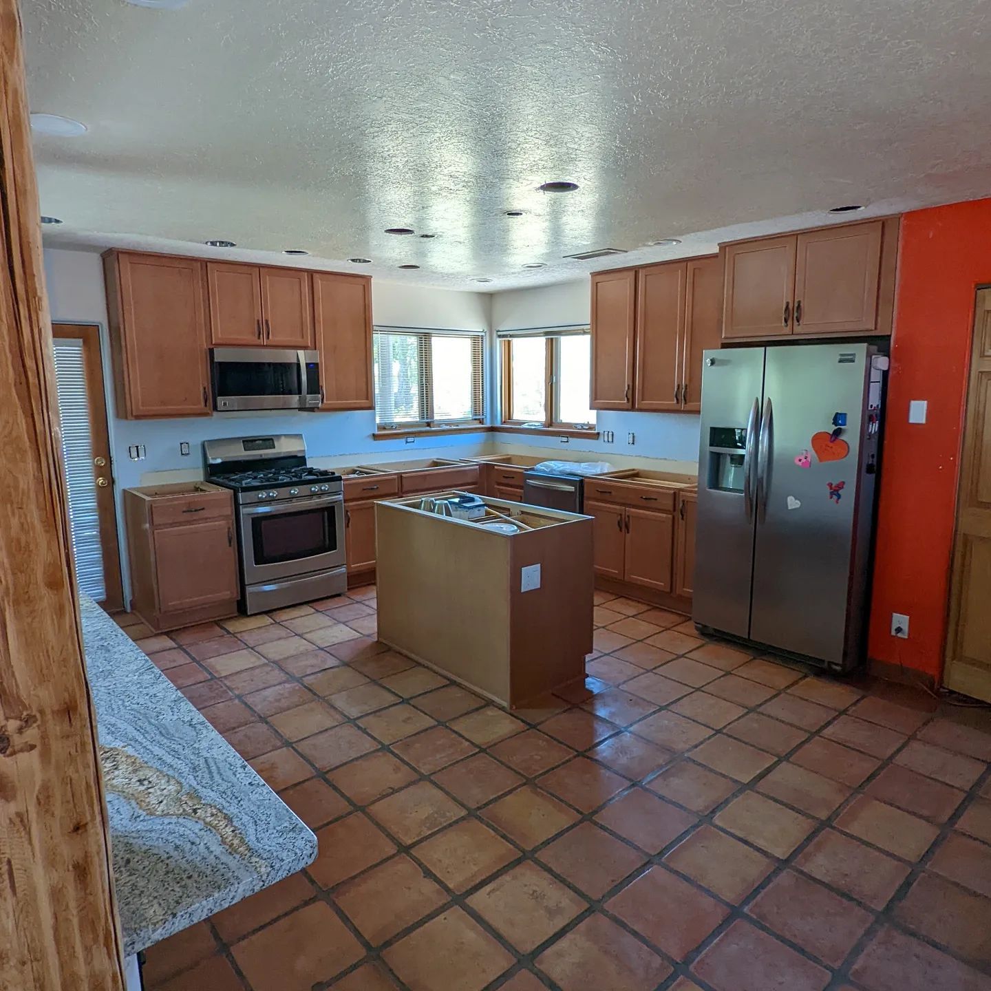 A kitchen with stainless steel appliances and wooden cabinets