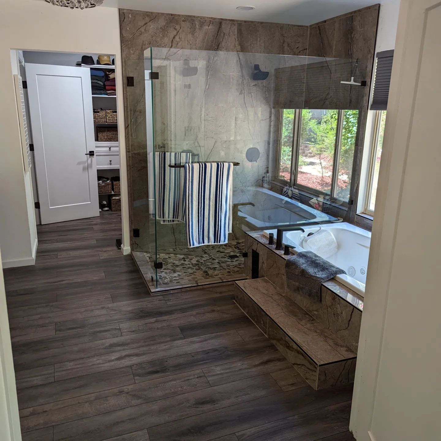 A bathroom with a walk in shower and a bathtub