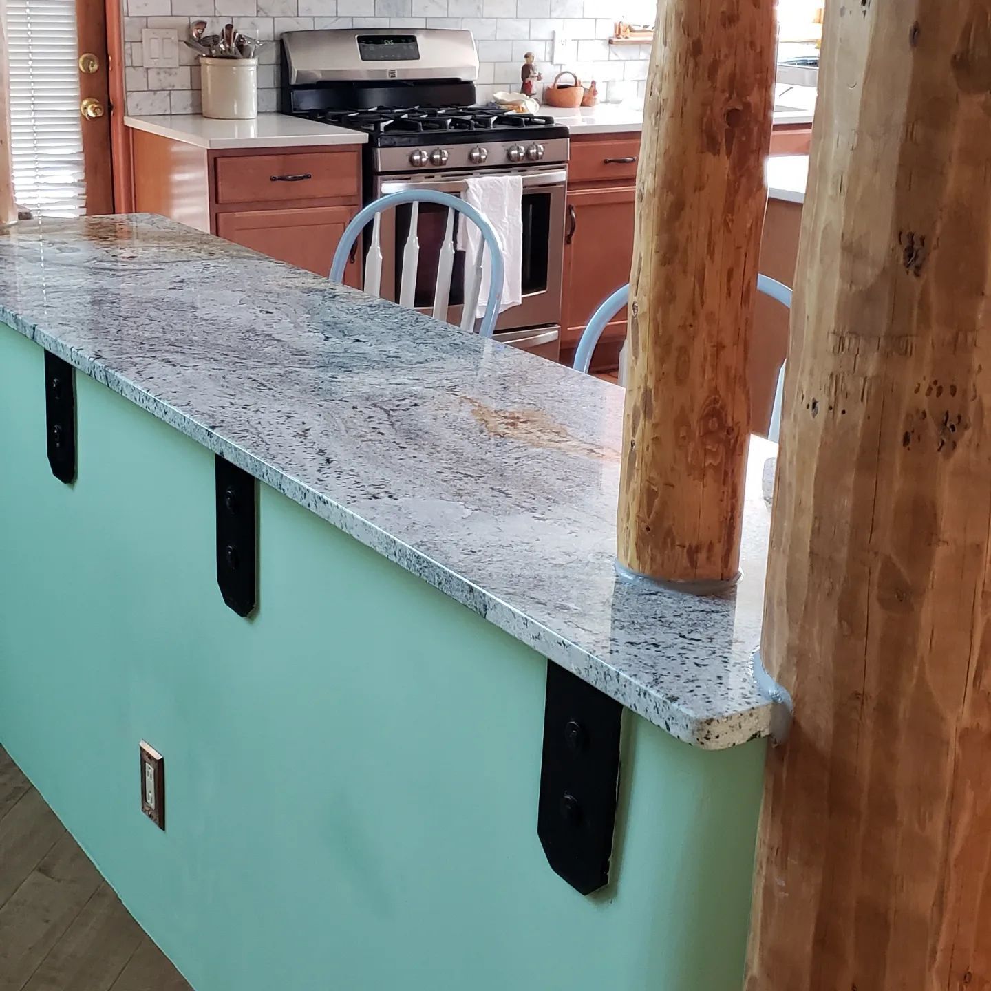 A kitchen with granite counter tops and a stove