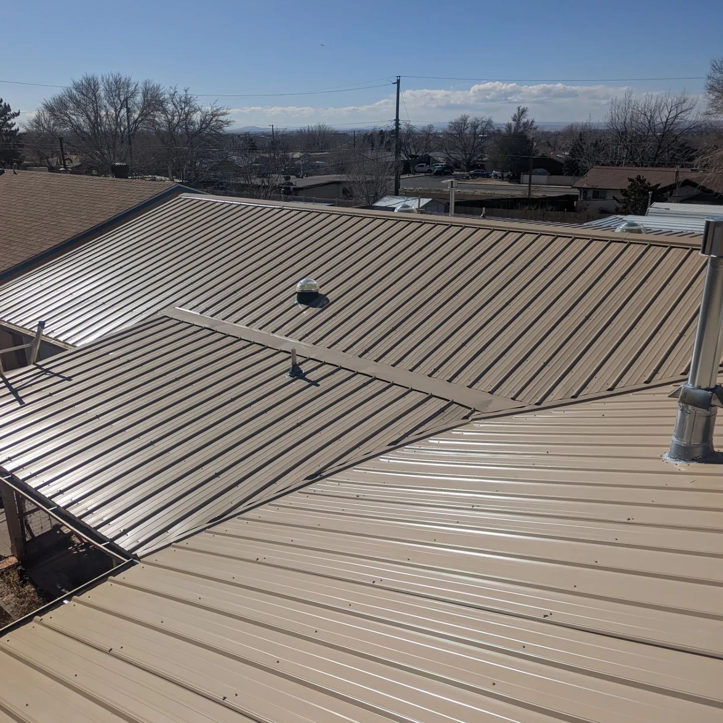 An aerial view of a metal roof on a house.