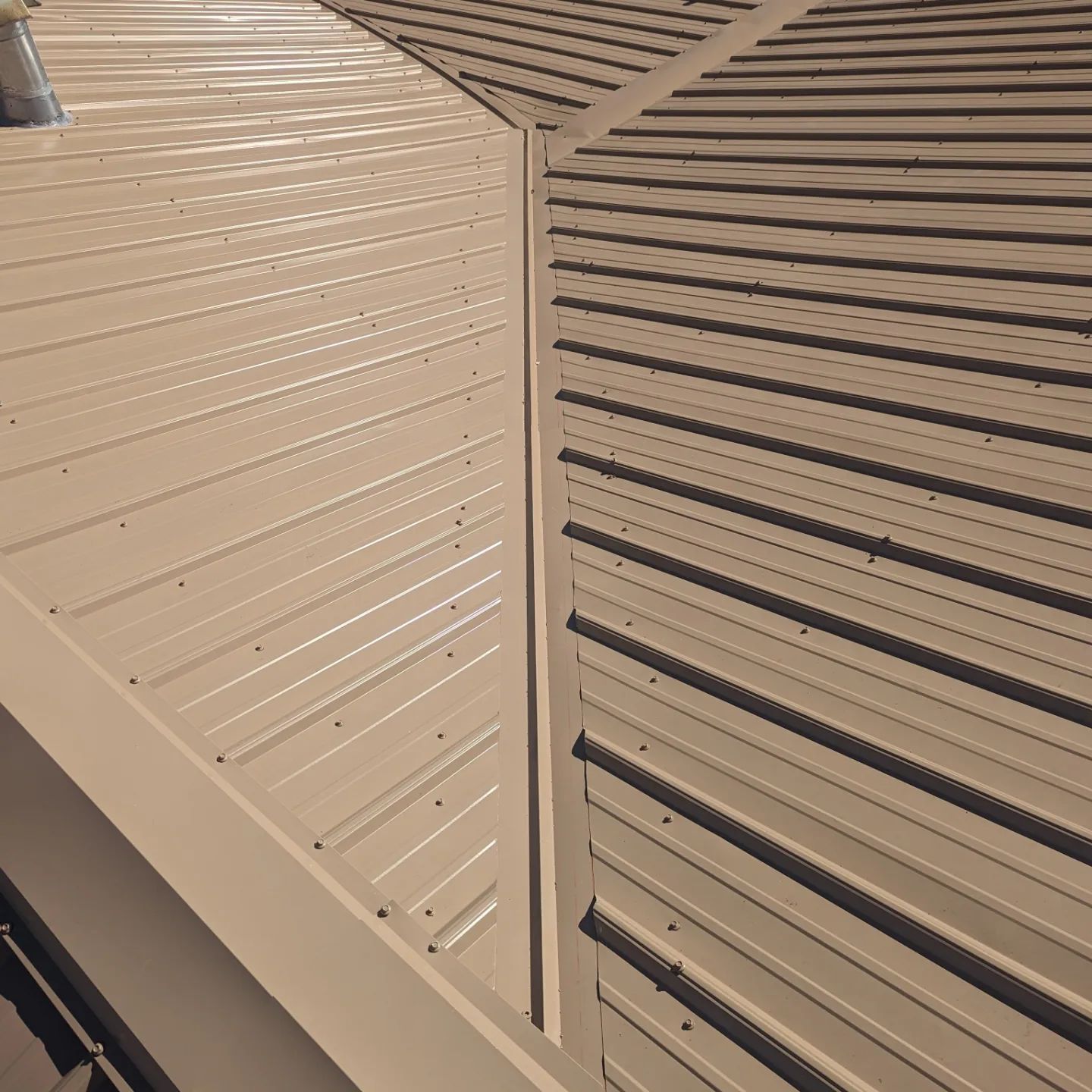 A close up of a roof with a chimney on it