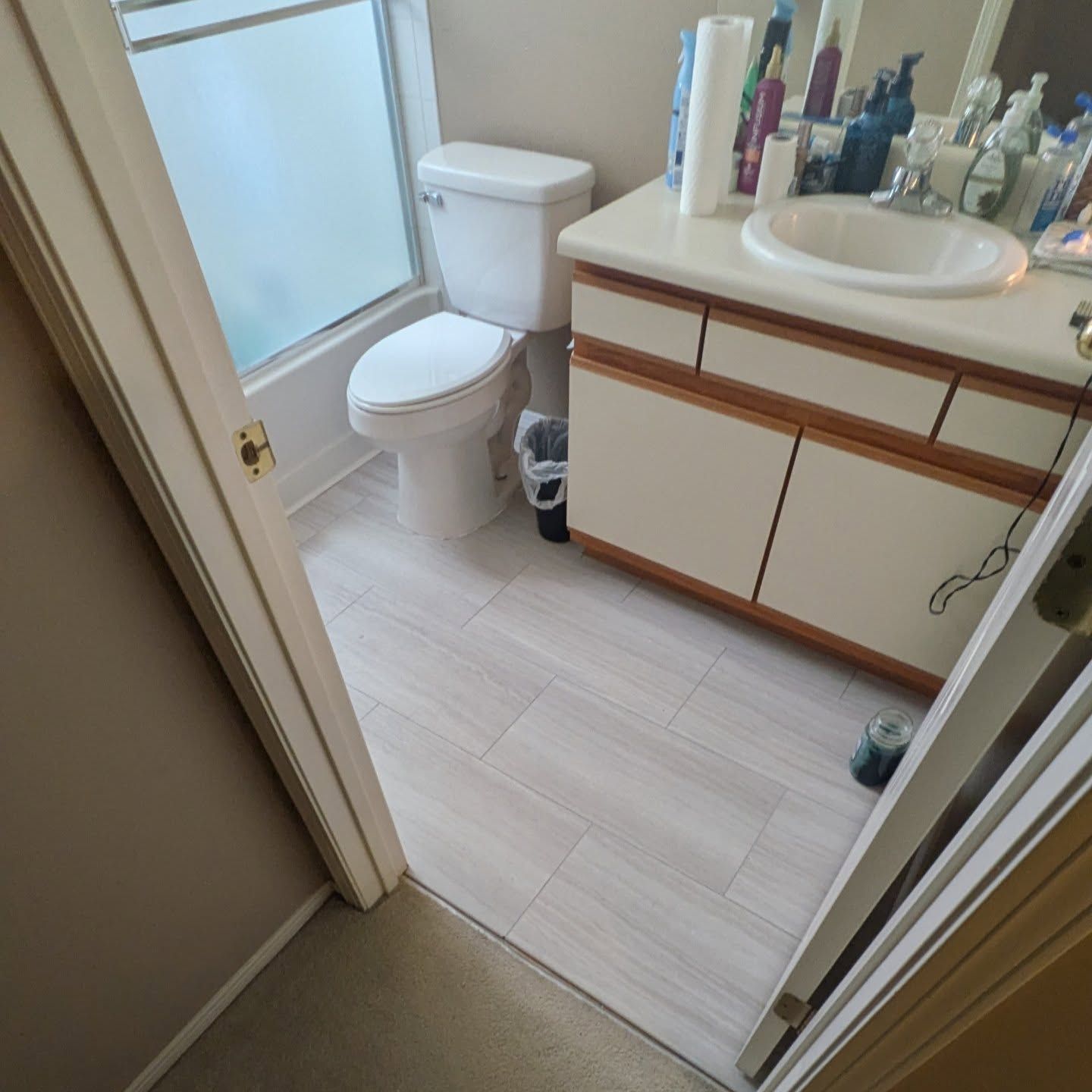 A bathroom with a toilet a sink and a mirror