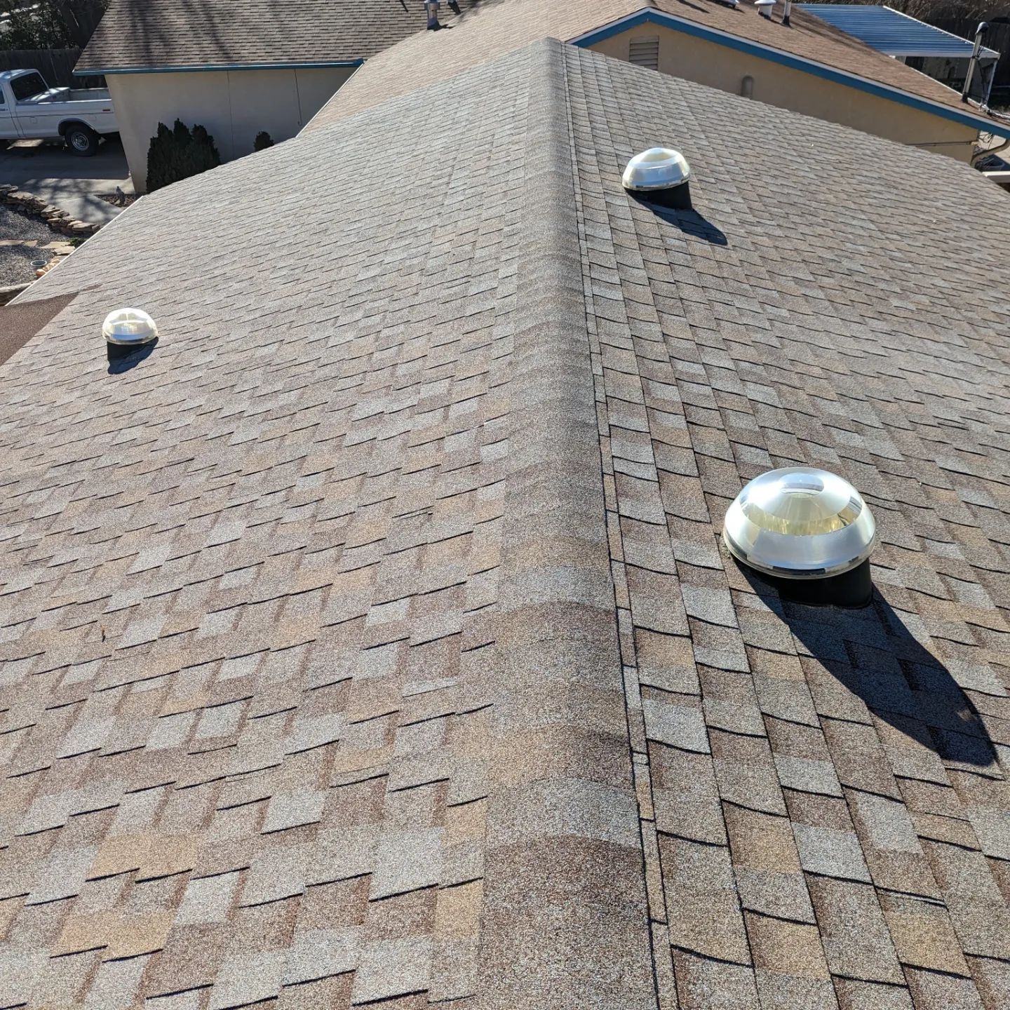 The roof of a house has three skylights on it