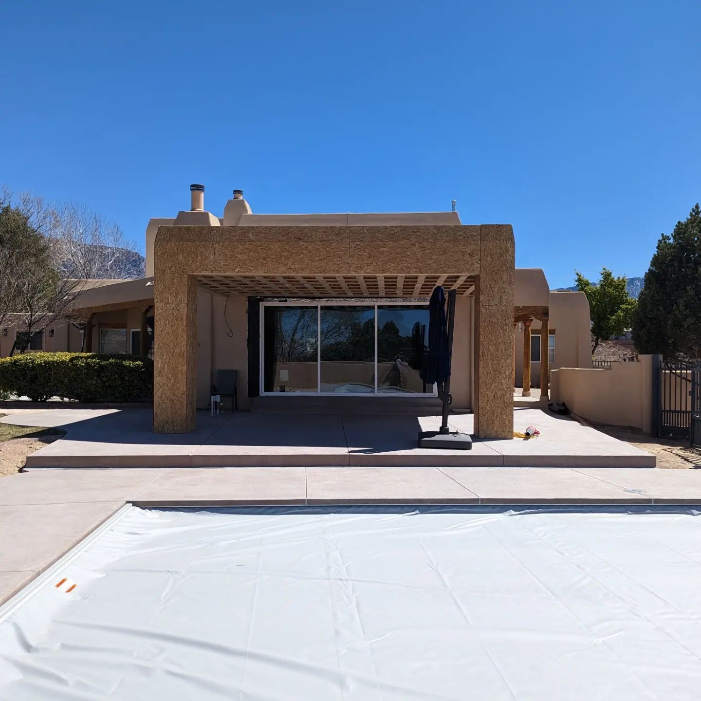 A large house with a large swimming pool in front of it