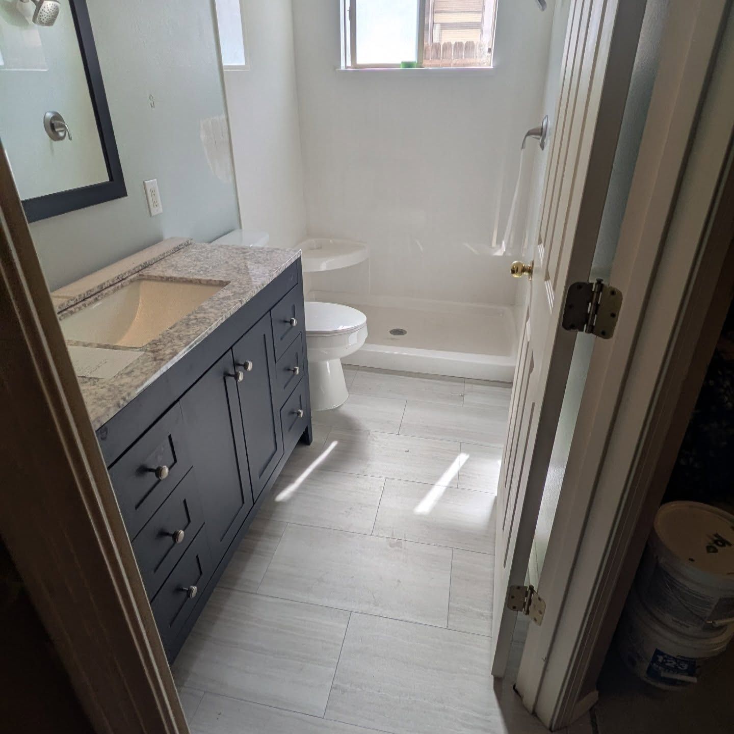 A bathroom with a sink , toilet , and shower.