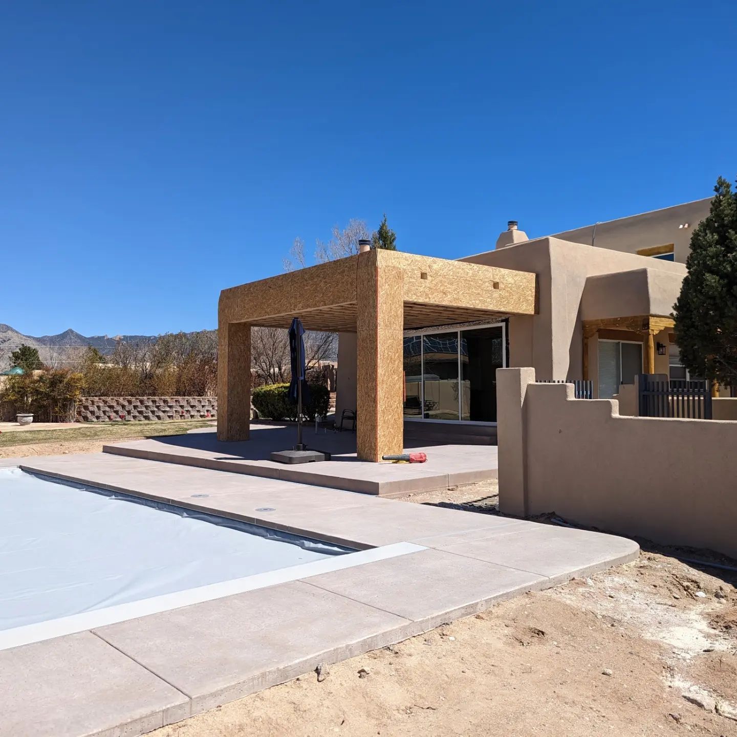 A large house with a swimming pool in front of it
