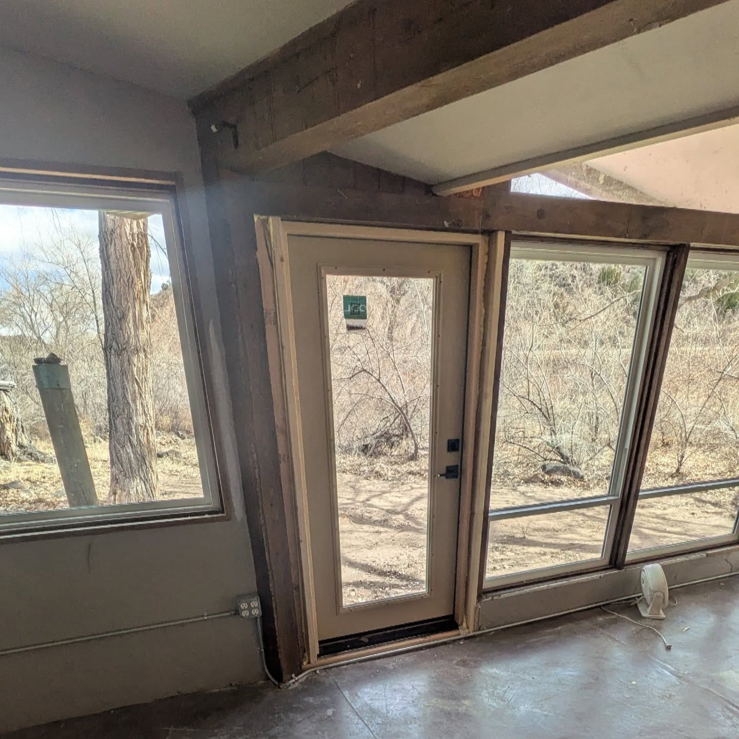 A room with a door and a lot of windows.