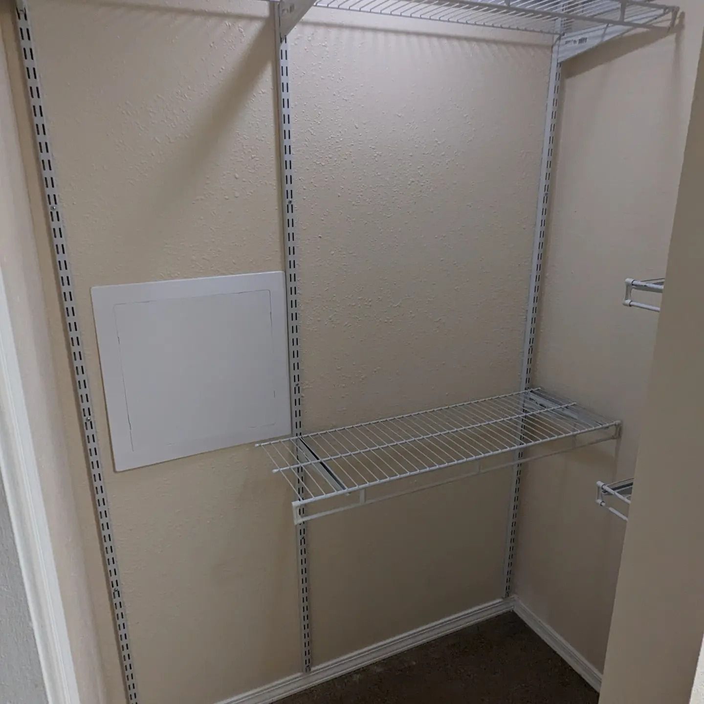 A walk in closet with shelves and a door