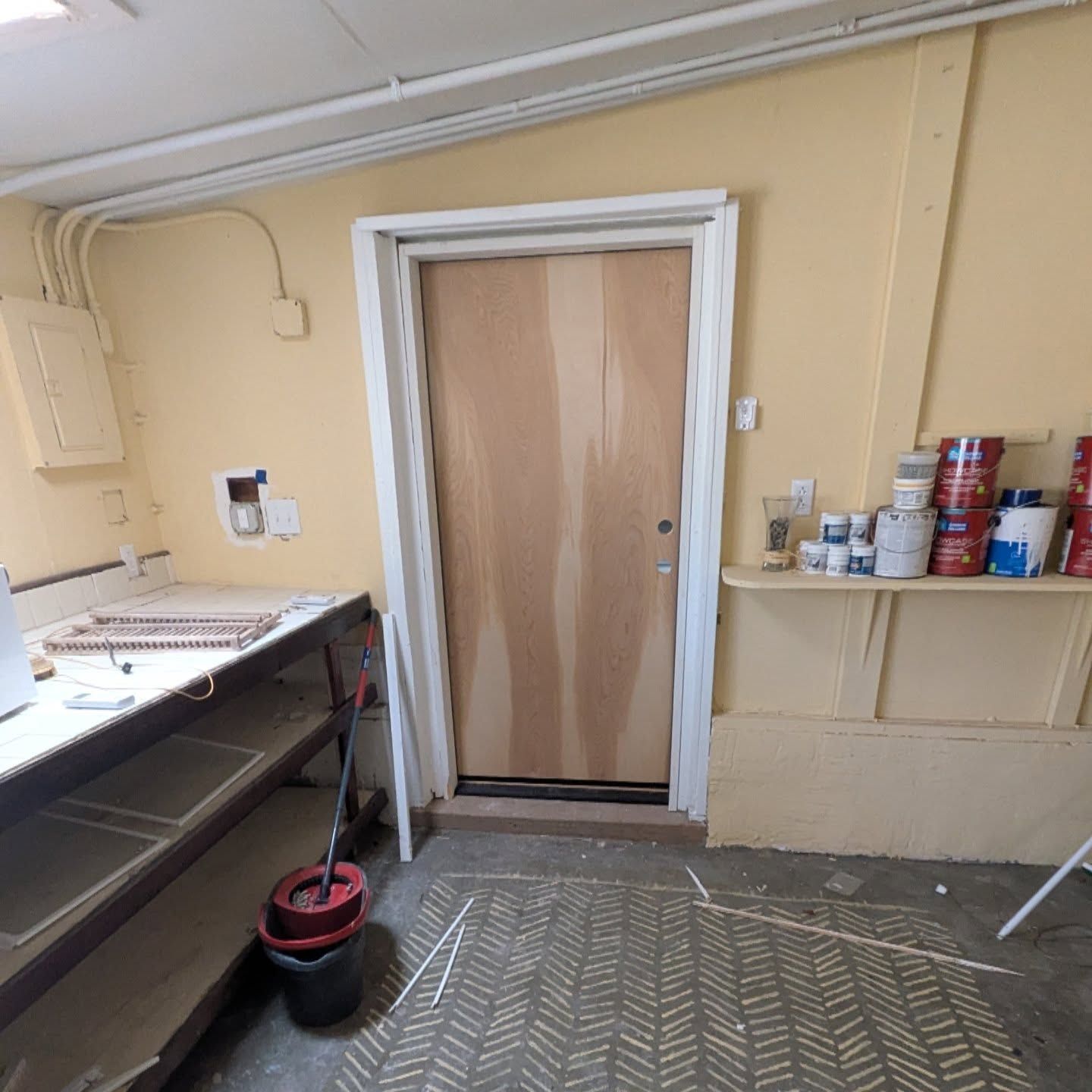 A room with yellow walls and a wooden door