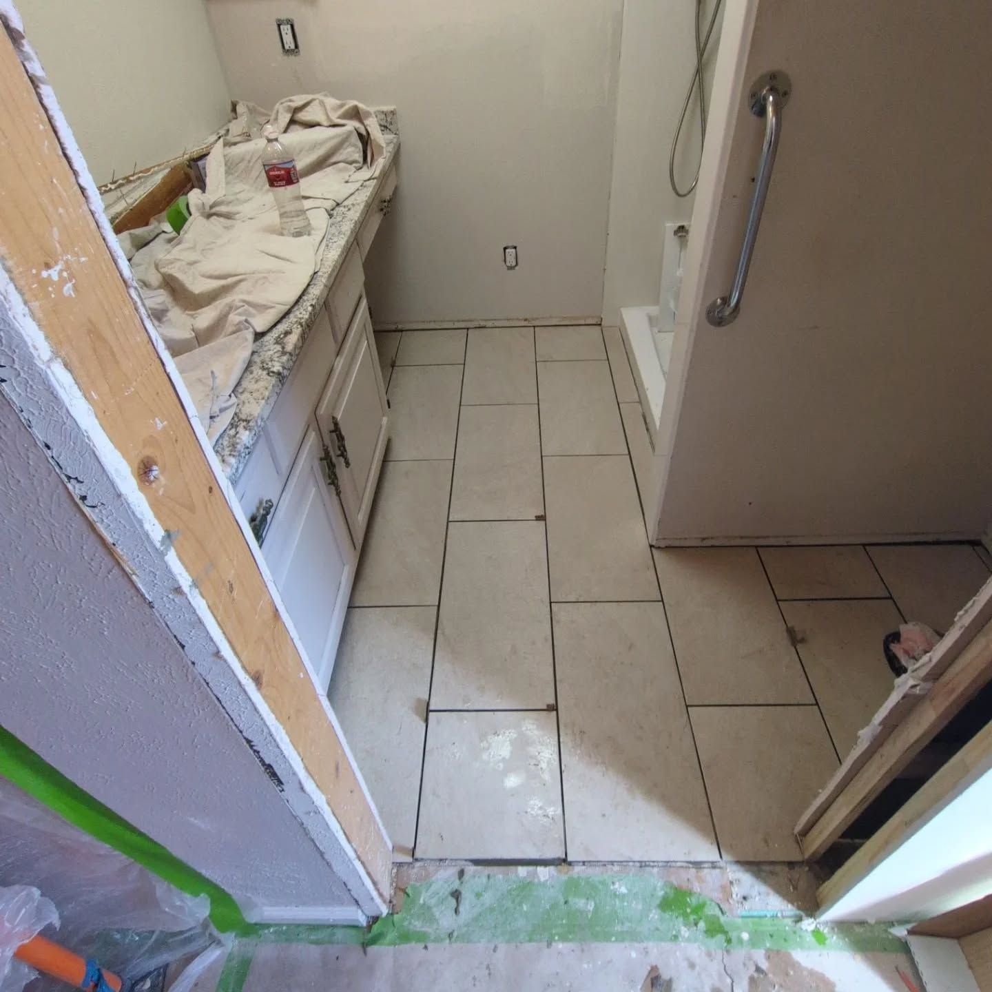 A bathroom with a sink and a shower being remodeled