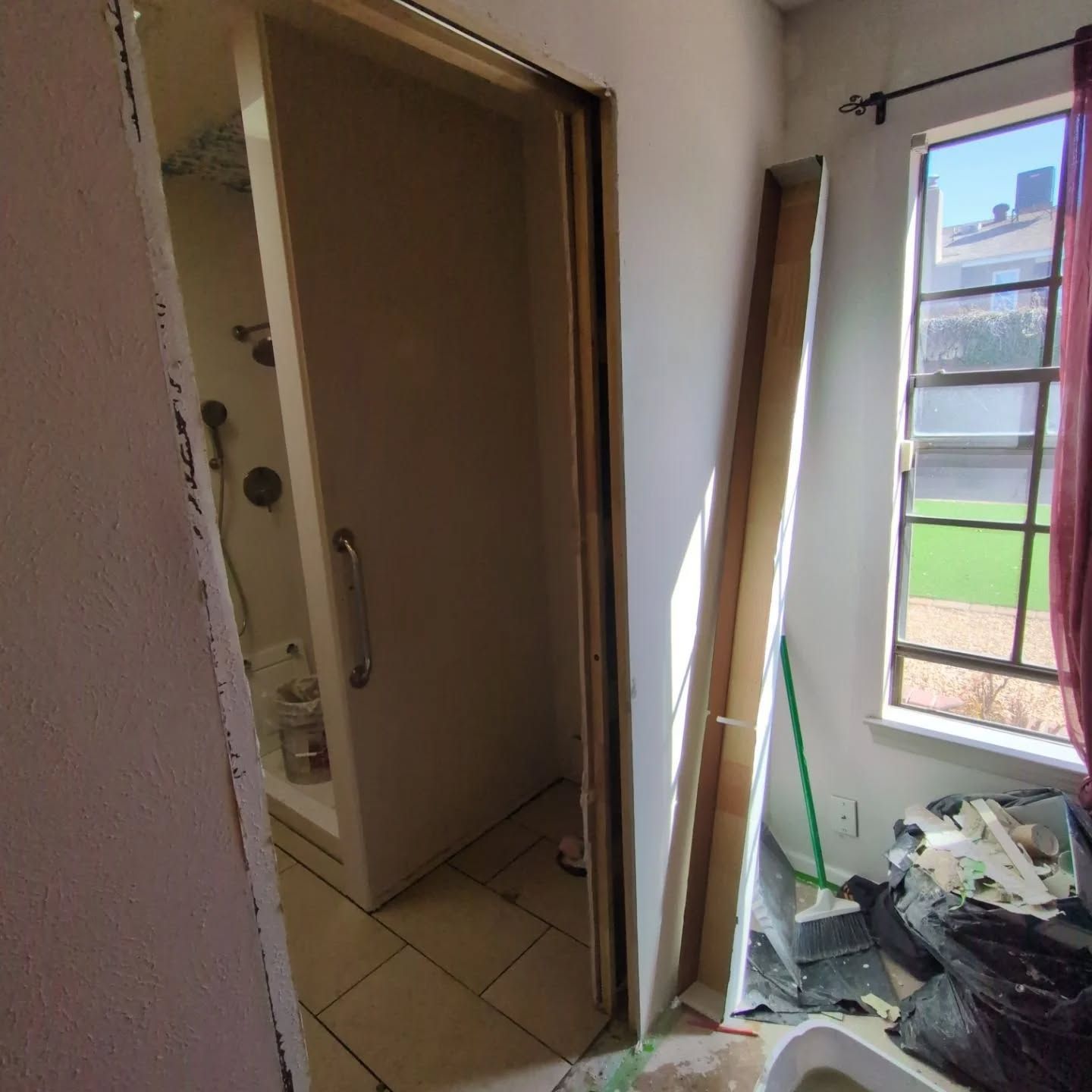 A bathroom with a sliding door and a window