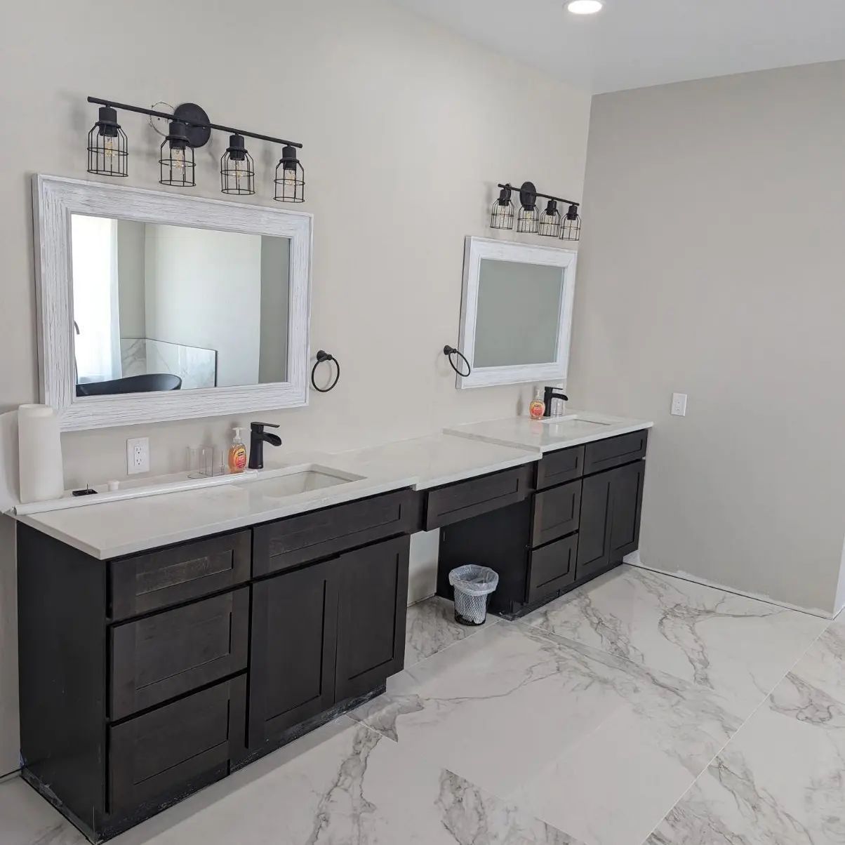 A bathroom with two sinks and two mirrors.