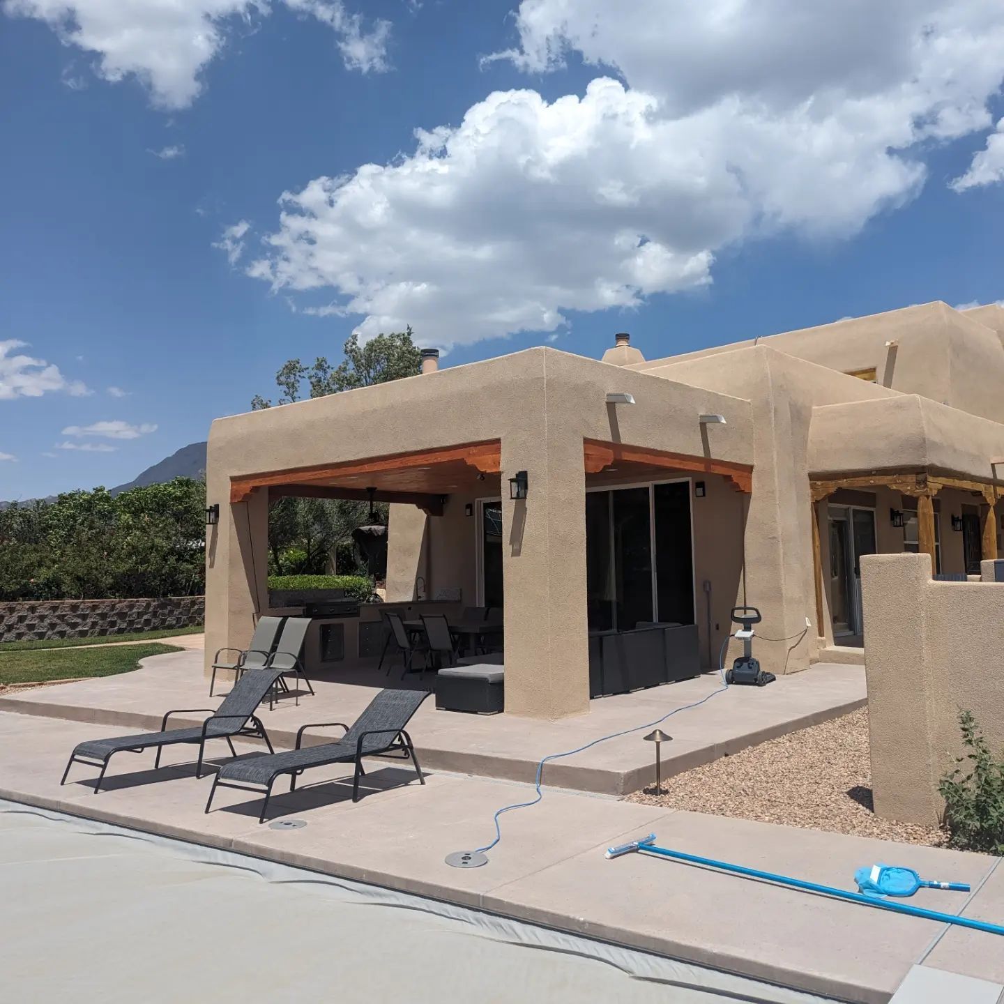 A large house with a patio and chairs in front of it