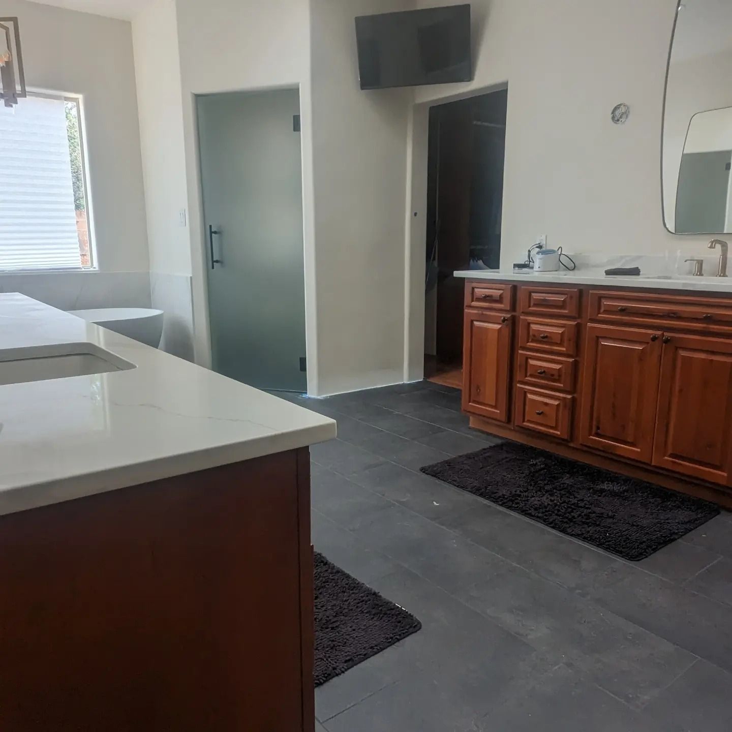 A bathroom with wooden cabinets and a sink