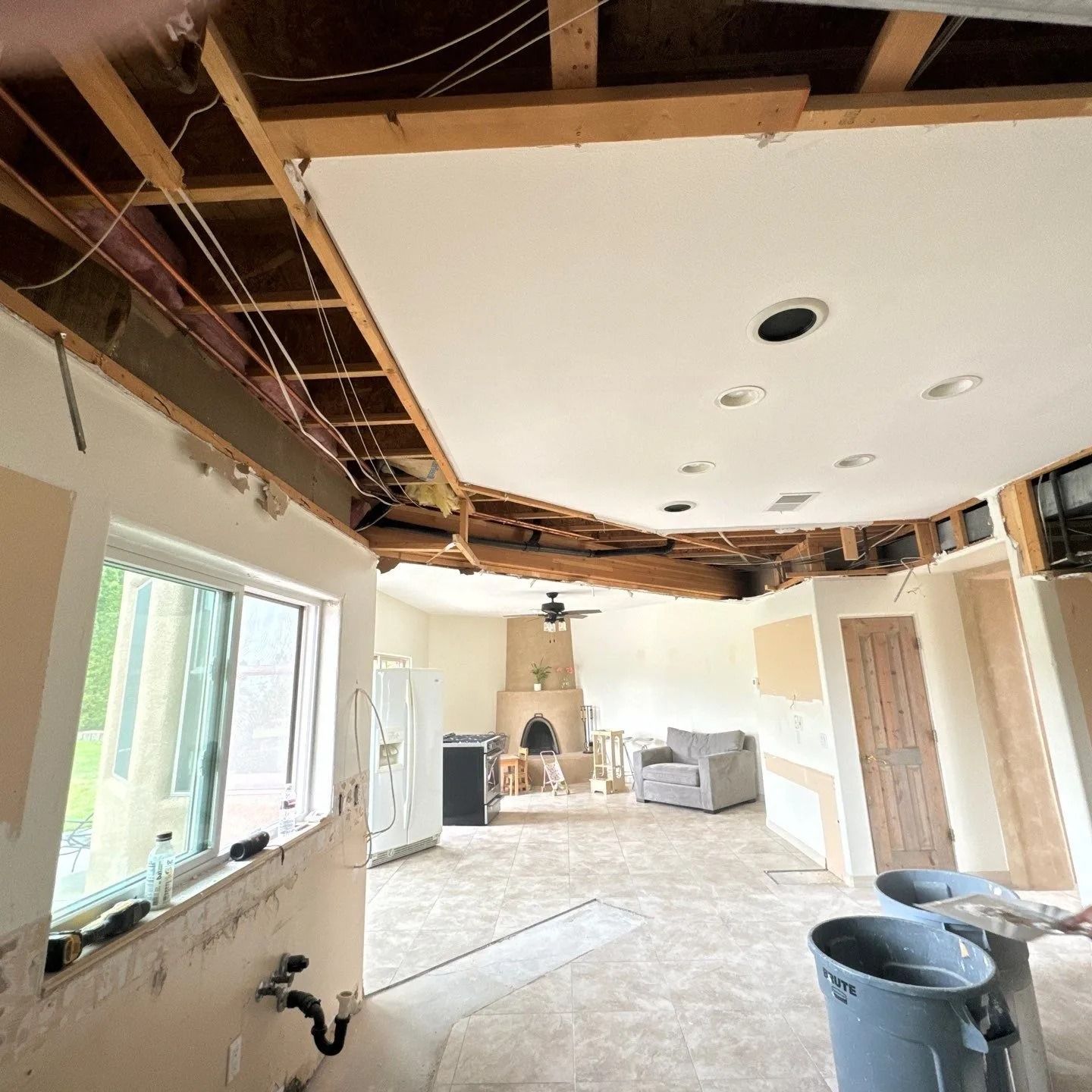 A living room with a ceiling that is missing