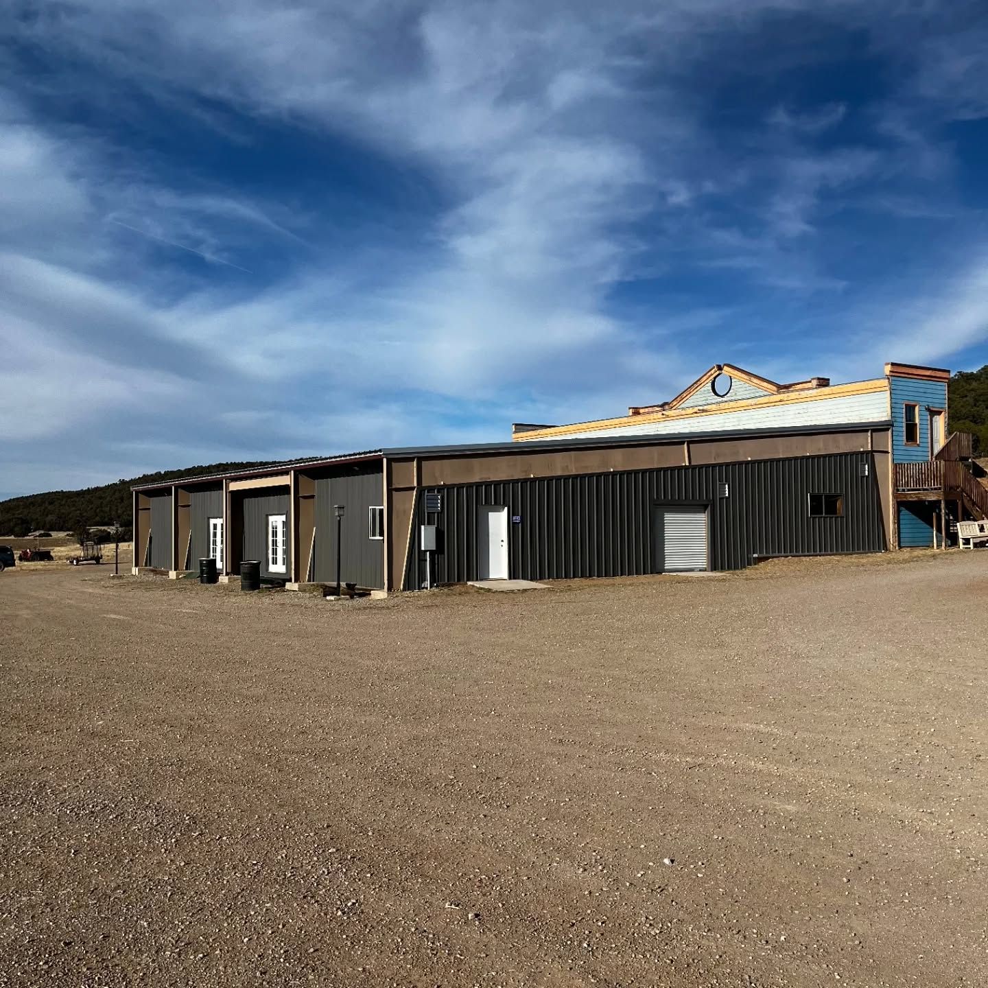 A large building in the middle of a dirt field