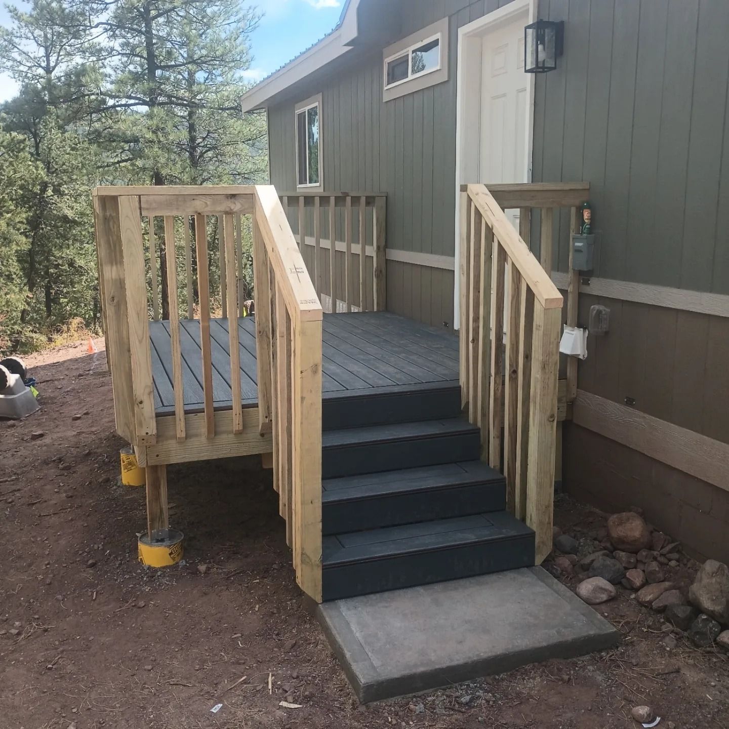A house with a deck and stairs leading up to it