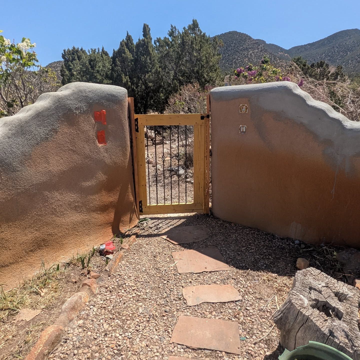 A stone wall with a gate that has the number 1 on it