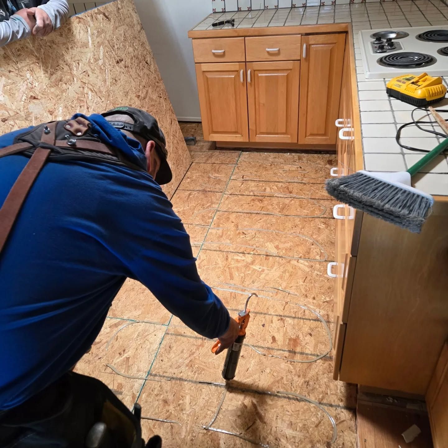A man in a blue shirt is working in a kitchen