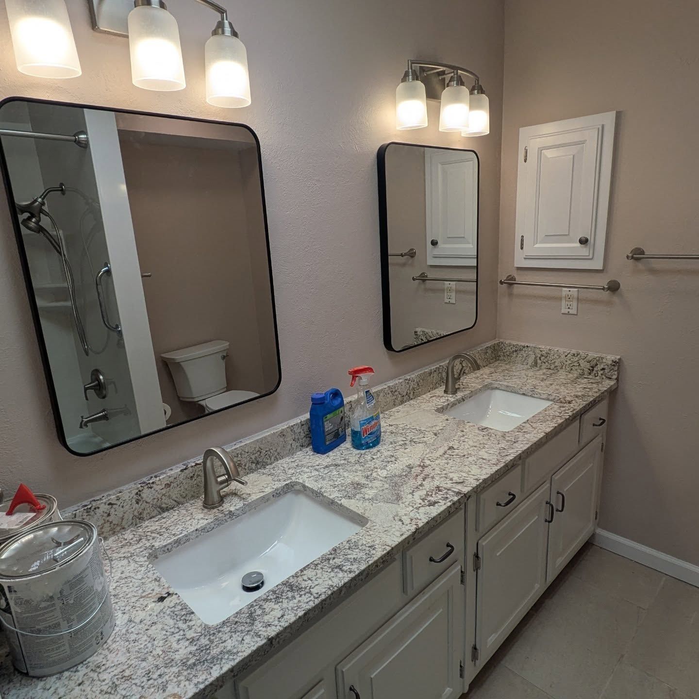 A bathroom with two sinks and two mirrors