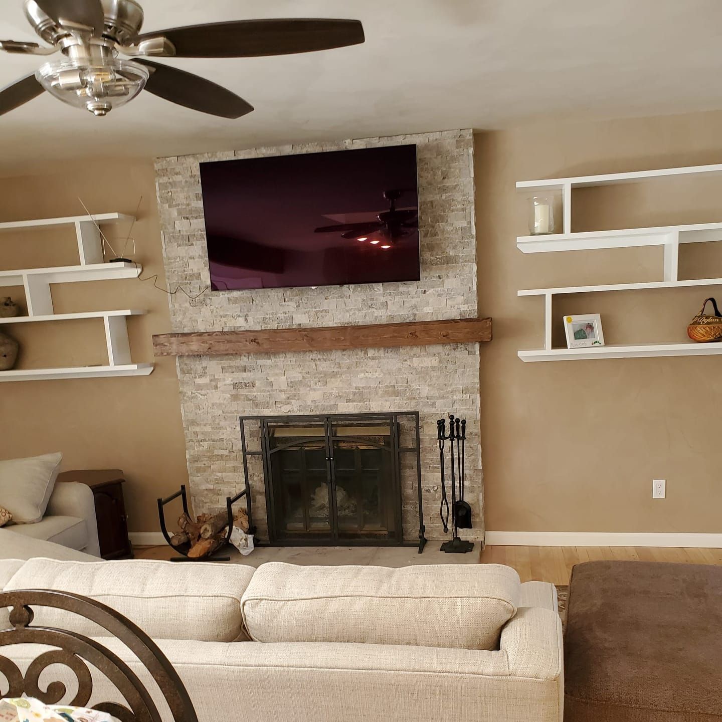 A living room with a fireplace and a flat screen tv