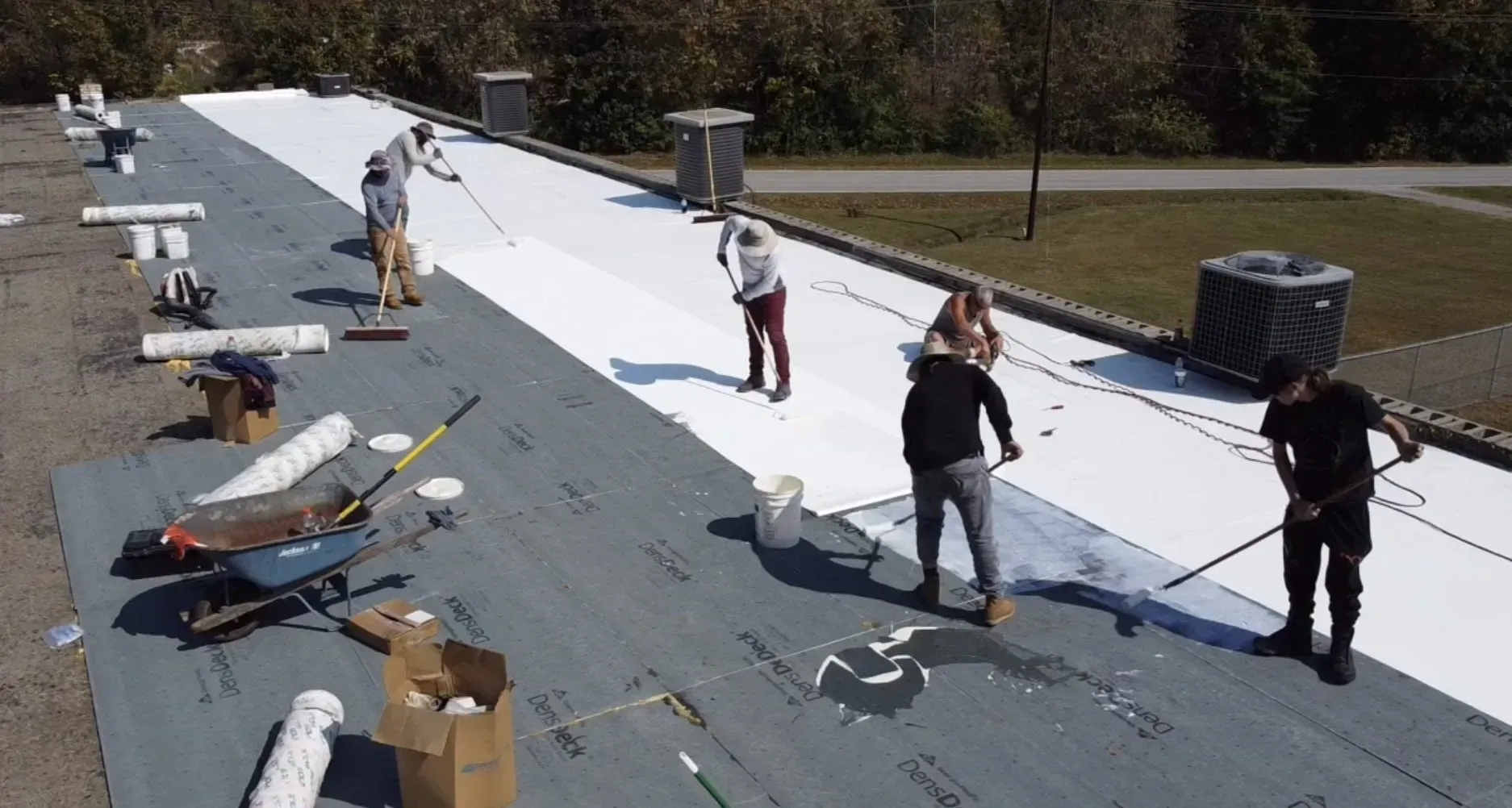 A group of people are working on a roof.