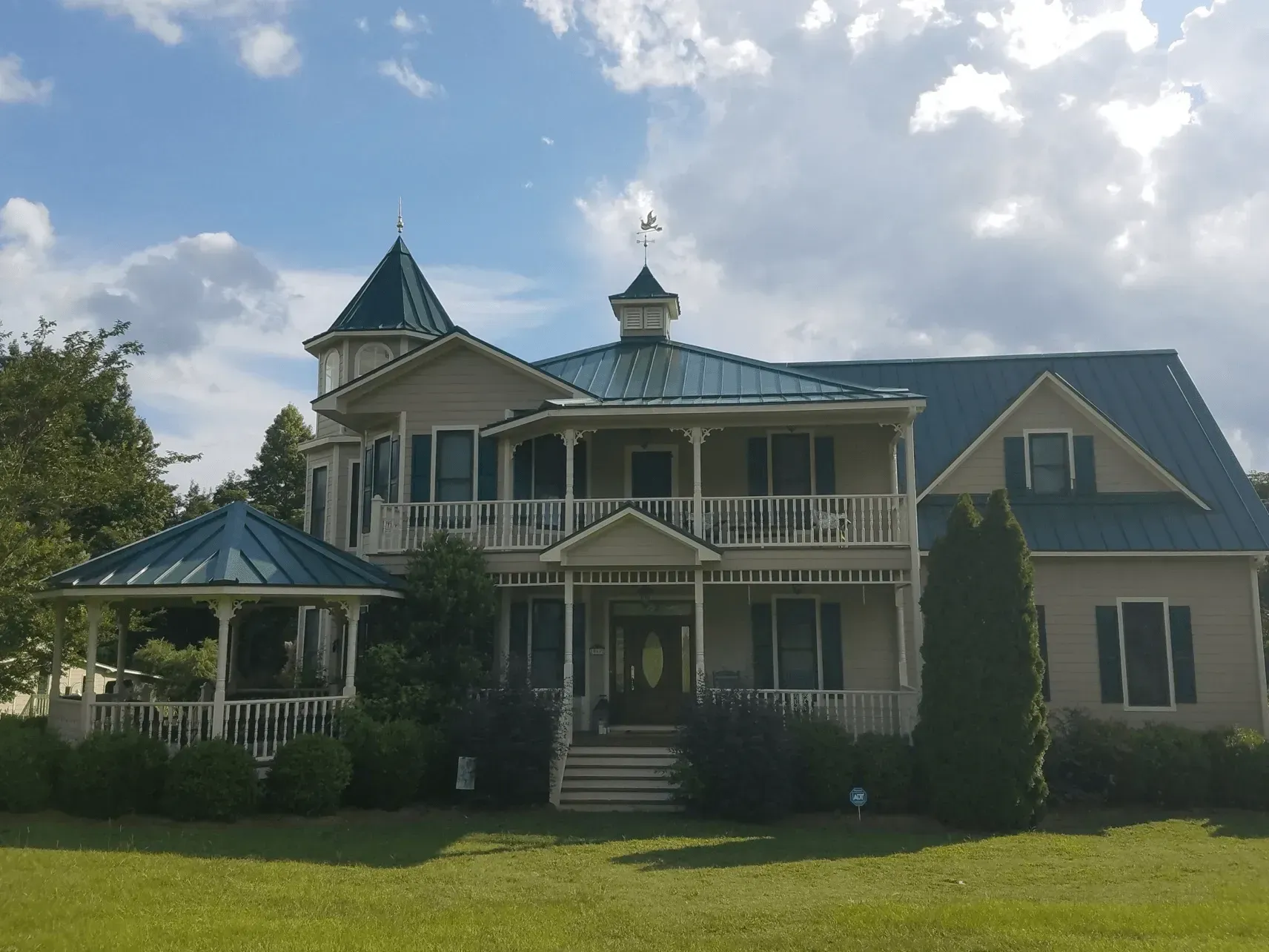 A large white house with a blue roof