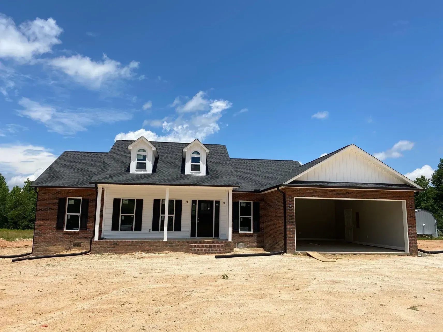 A brick house with a garage underneath it