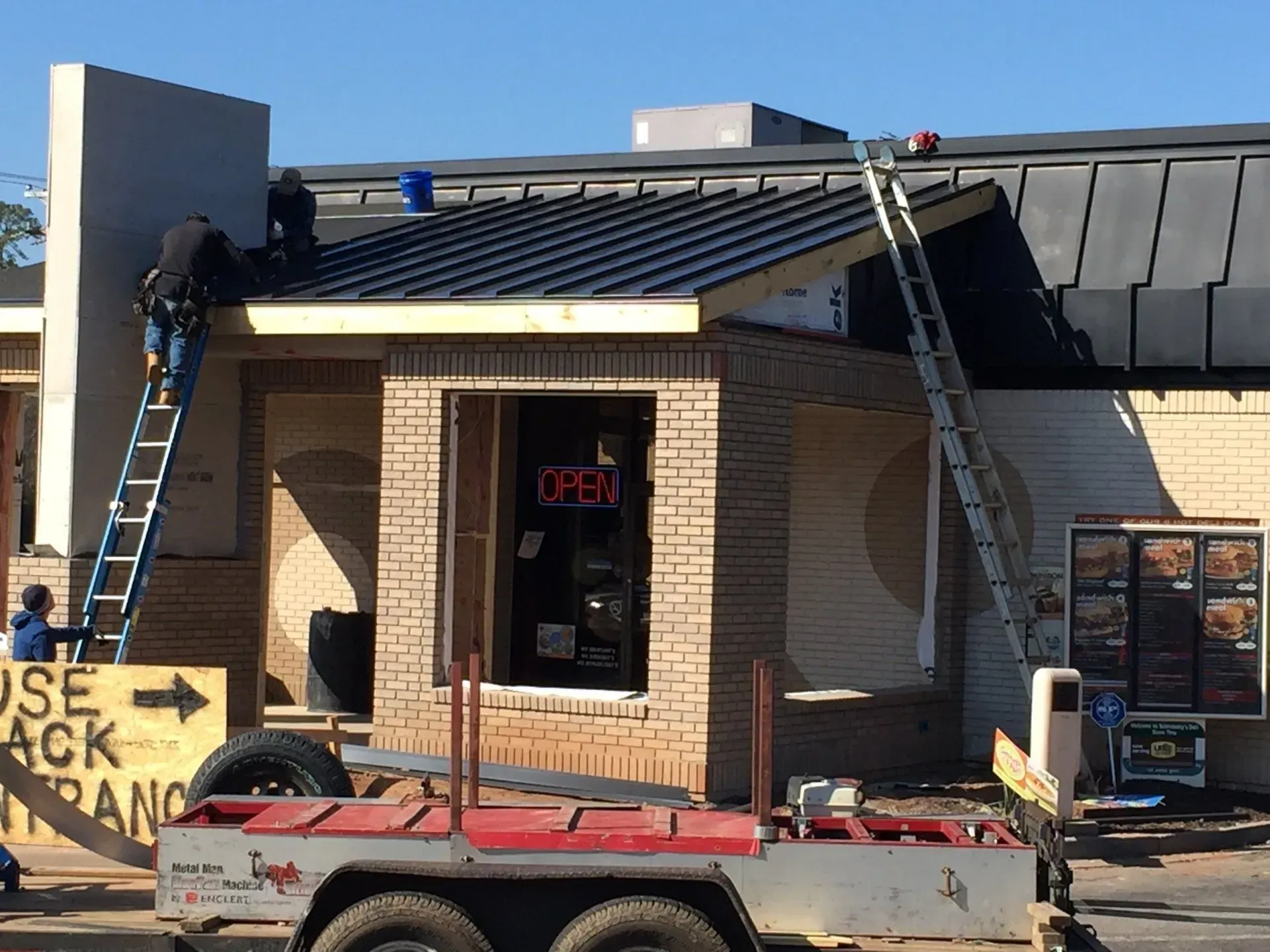 A trailer is parked in front of a building under construction.