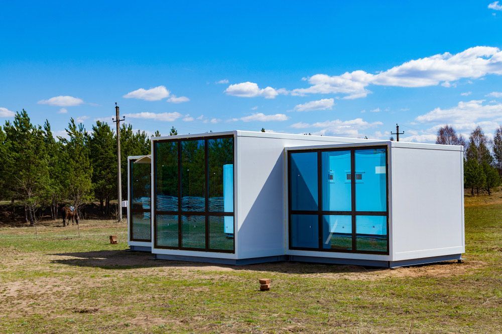 A White Building with A Lot of Windows Is Sitting in The Middle of A Field — Alternative Modular Home In Toowoomba City, QLD