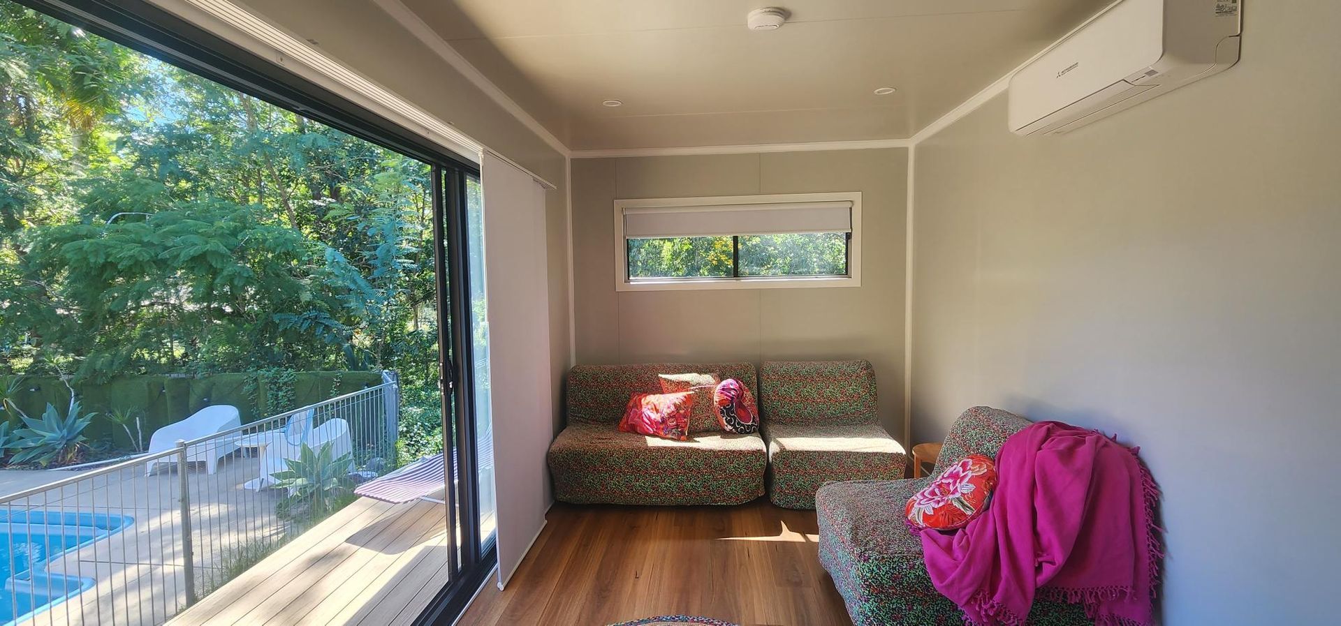 A Living Room with A Couch and Chairs and A Large Window — Alternative Modular Home In Toowoomba City, QLD