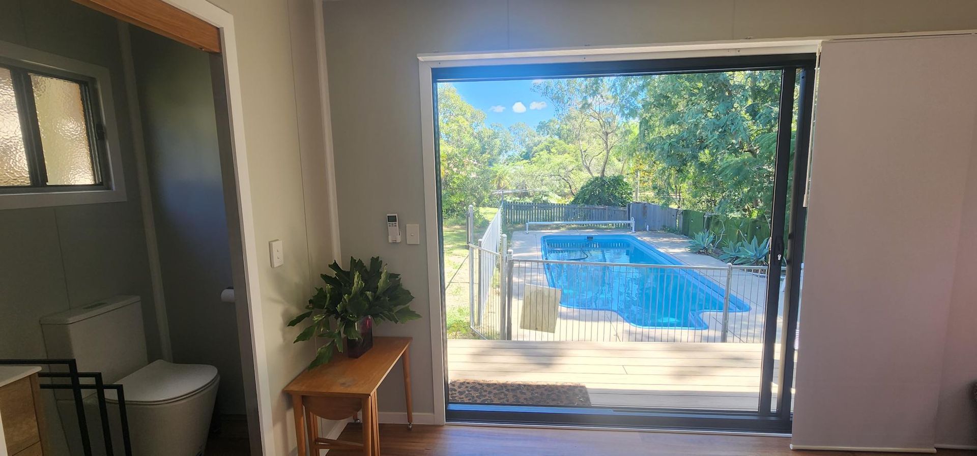 A Room with A Sliding Glass Door Leading to A Swimming Pool — Alternative Modular Home In Toowoomba City, QLD
