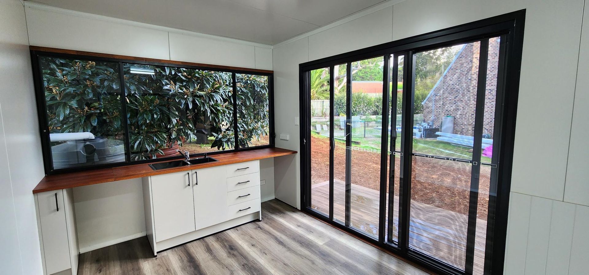 A Room with A Lot of Windows and Sliding Glass Doors — Alternative Modular Home In Toowoomba City, QLD