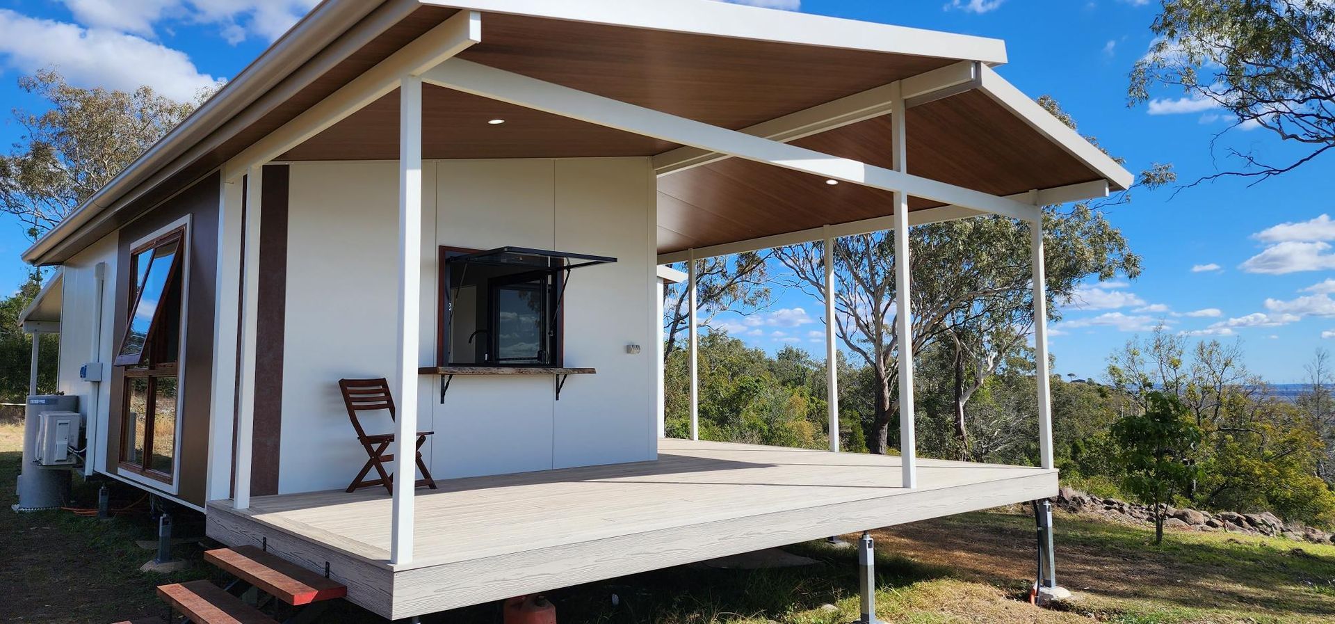 A Small House with A Porch and A Chair on It — Alternative Modular Home In Toowoomba City, QLD
