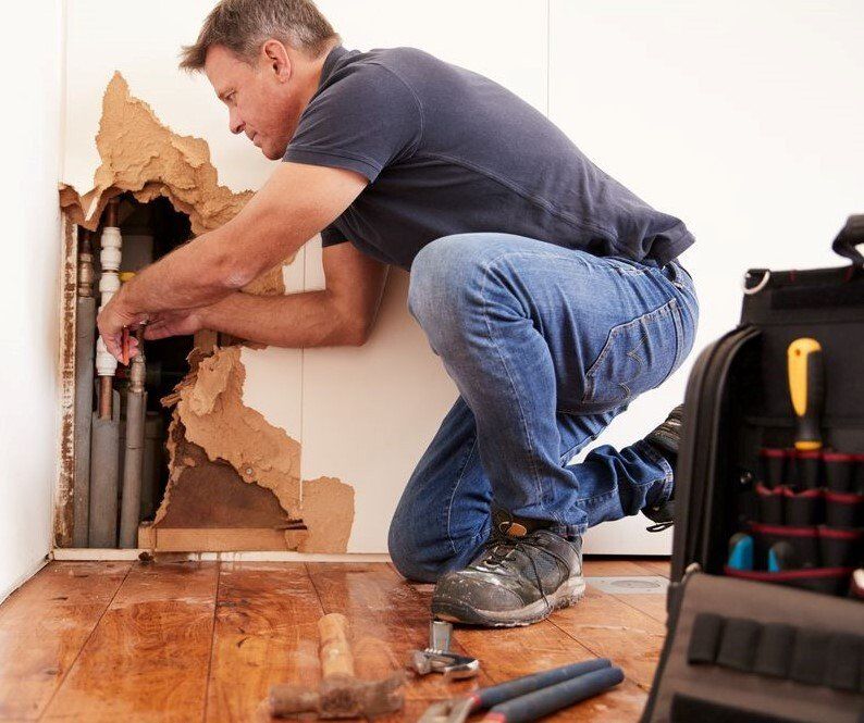 Man Repairing Burst Pipe — Carpet Cleaning In Tuncurry, NSW
