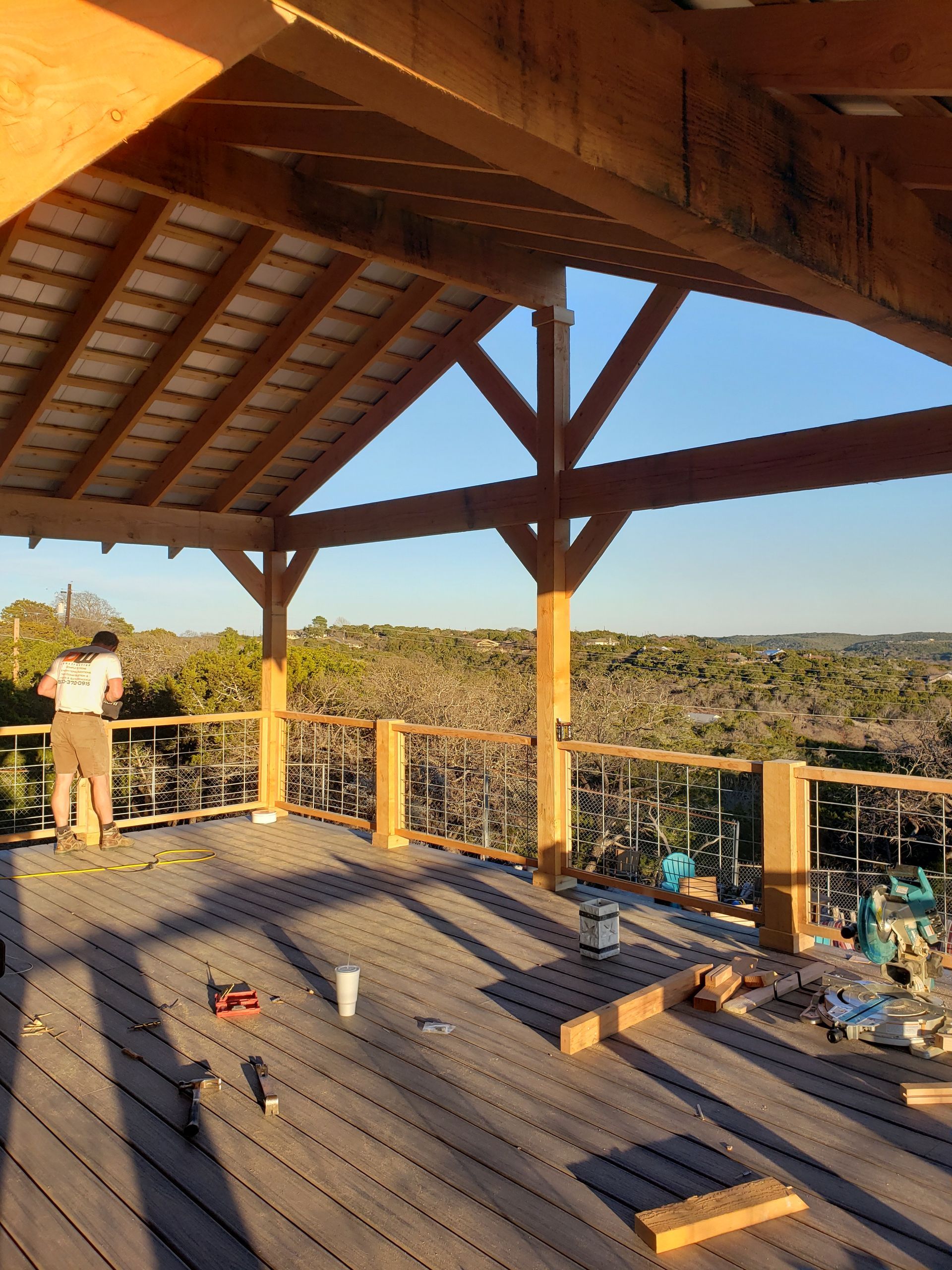 Working on a wooden deck with a view of the Texas Hill Country.