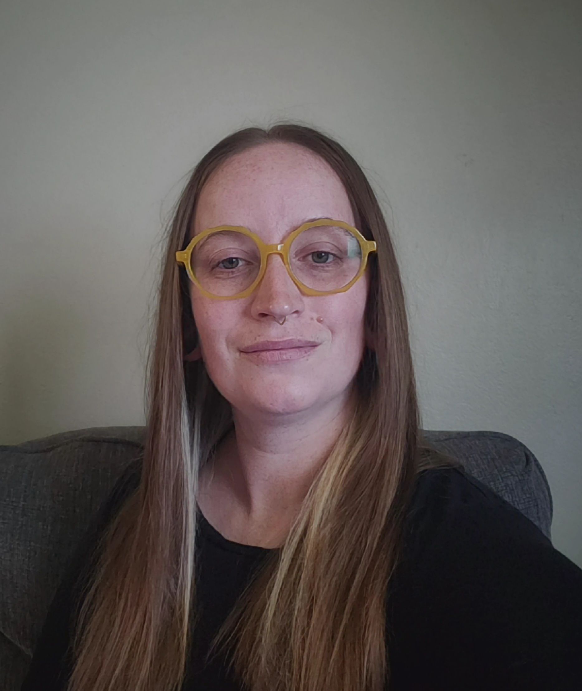 Two Salon Brown Shower hairs with various hair products on shelves above beside a beautiful clock and a hair cutting chair with a painting above.