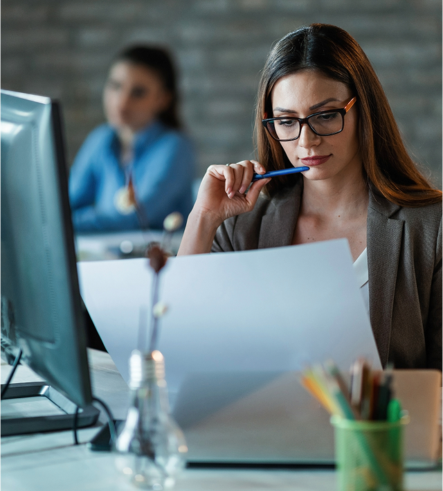 Person typing on a laptop with transparent checklist icons overlaid, one marked complete.
