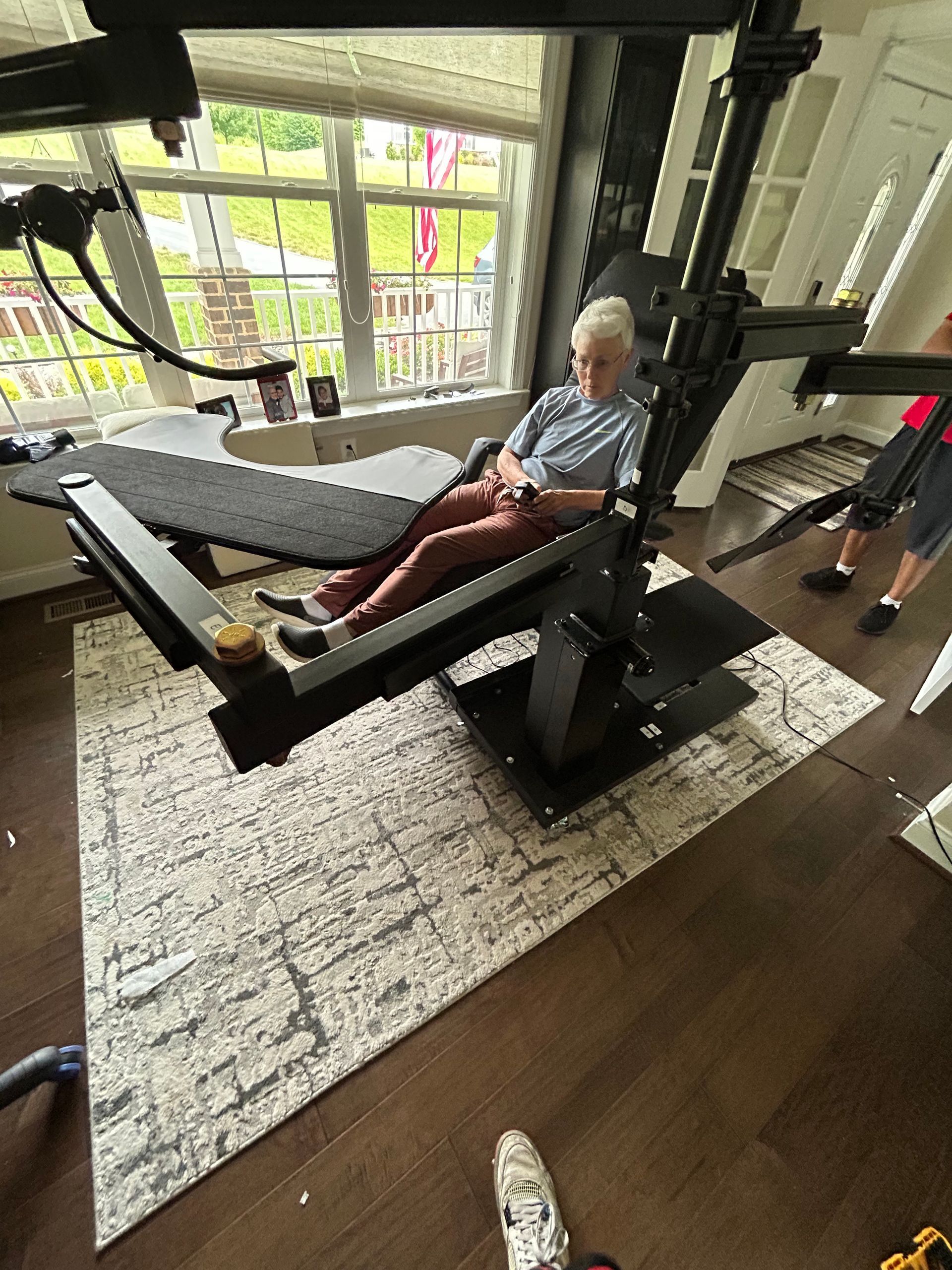 An elderly man is sitting in a chair in a living room.