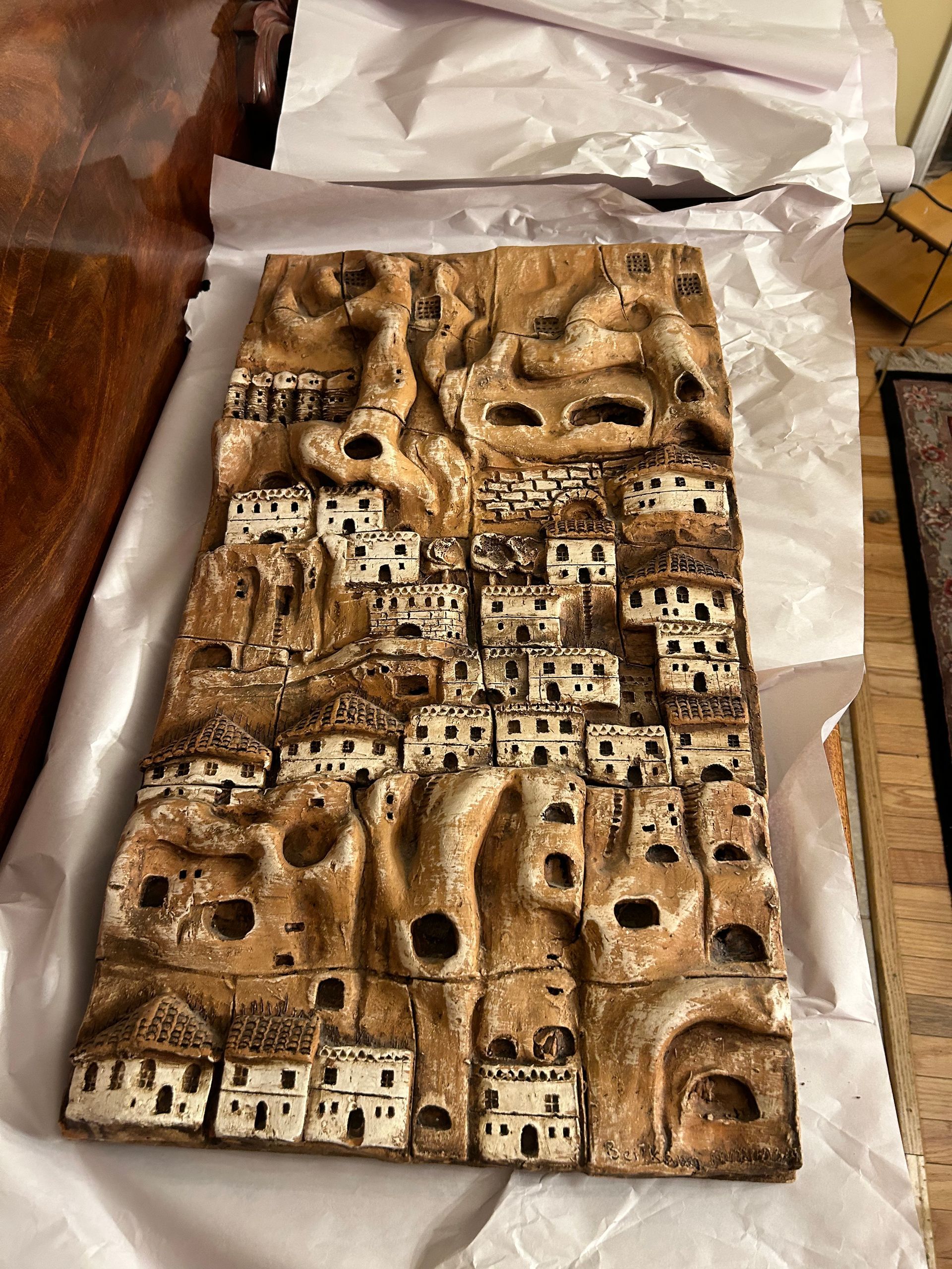 A sculpture of a village is sitting on a table