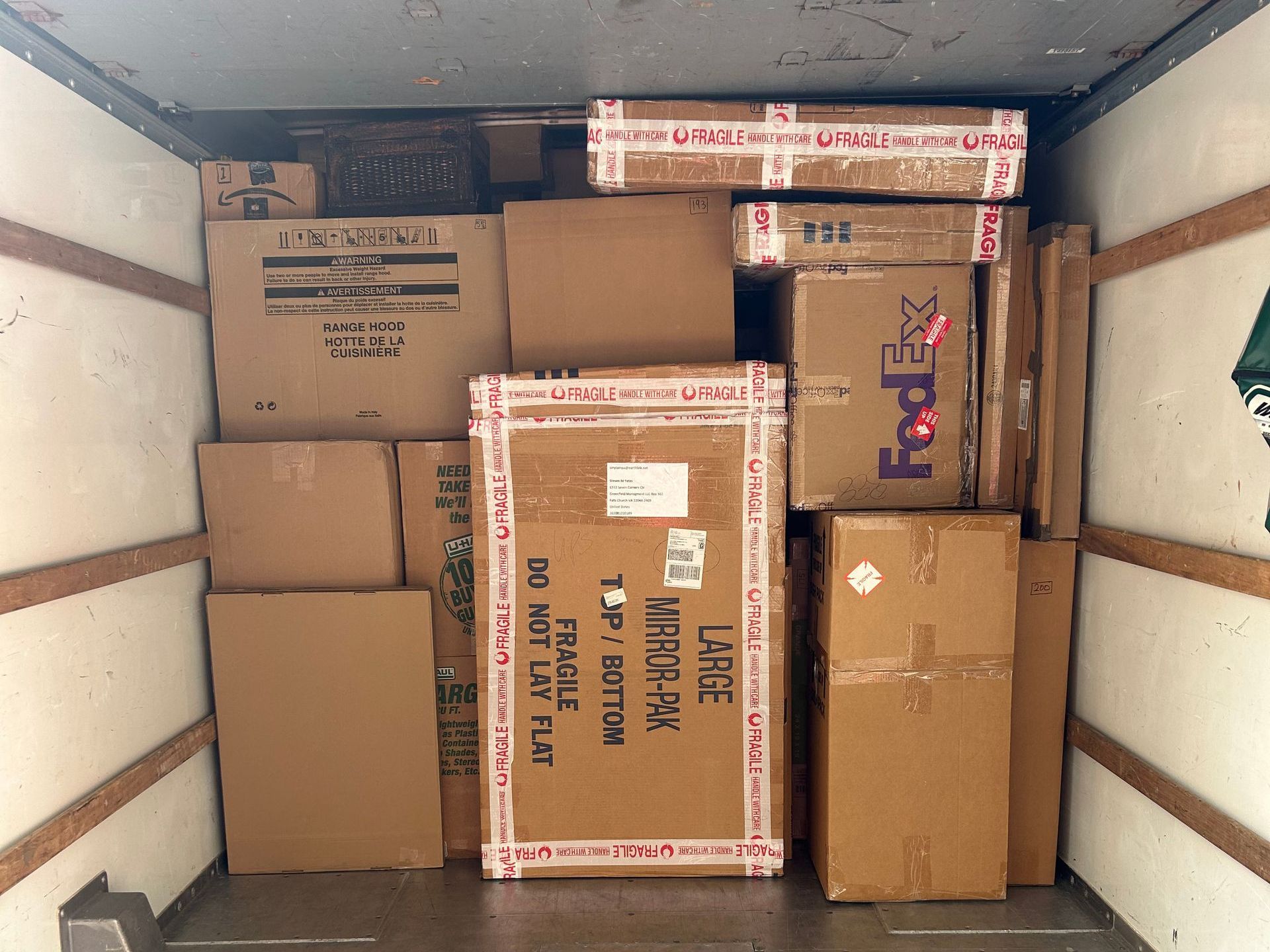 The inside of a fedex truck filled with cardboard boxes