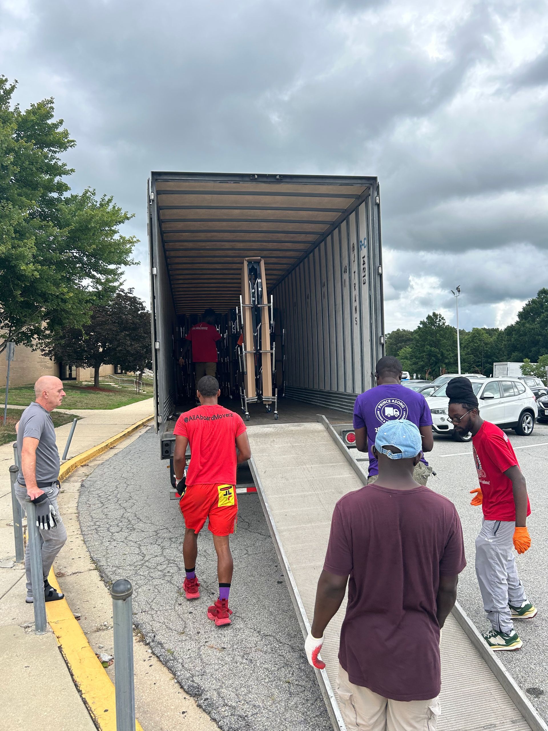A group of men are standing in front of a large truck.